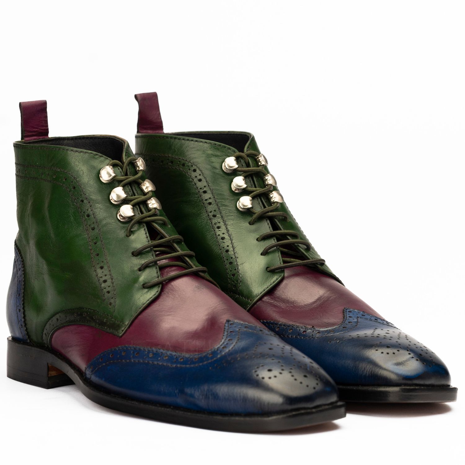 Green and burgundy leather dress shoes on a white background