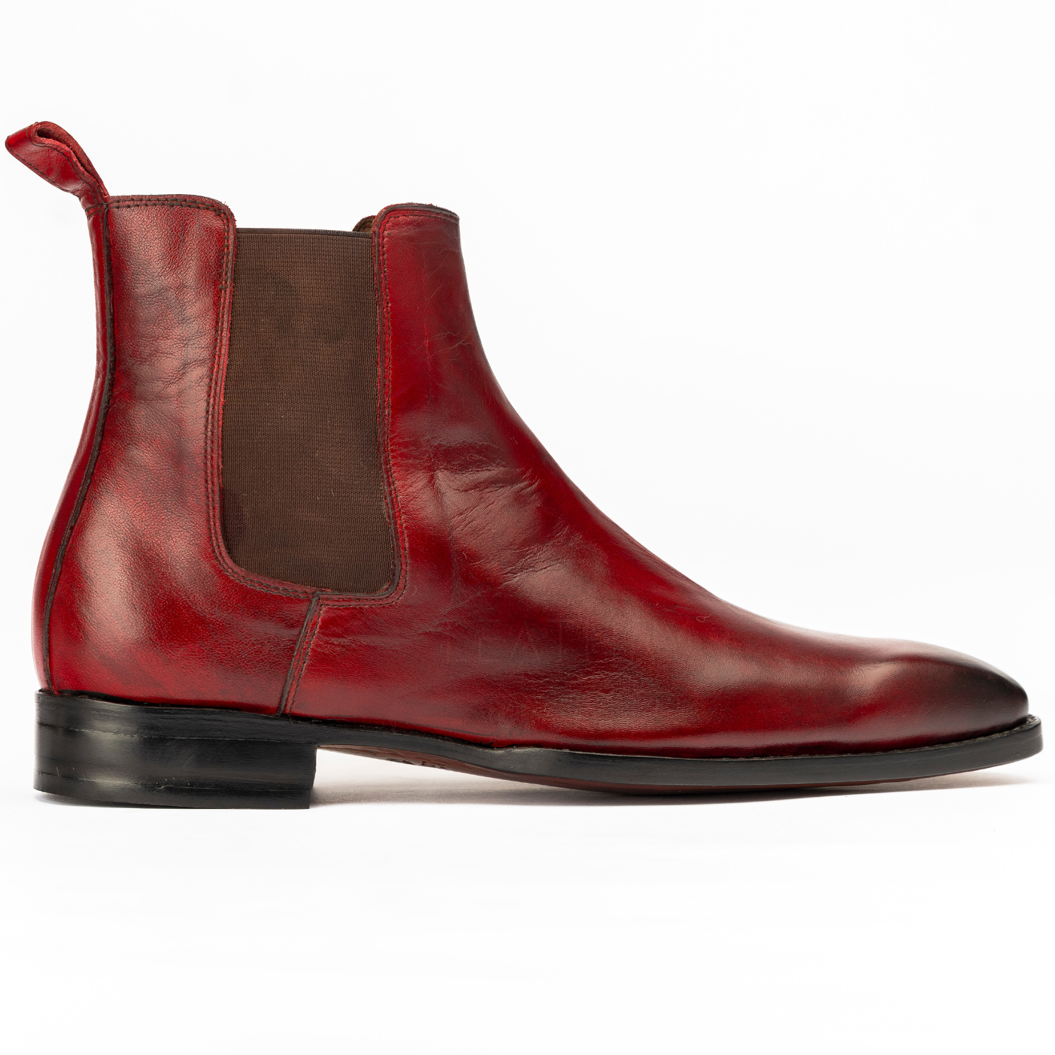 Red leather Chelsea boot on a white background