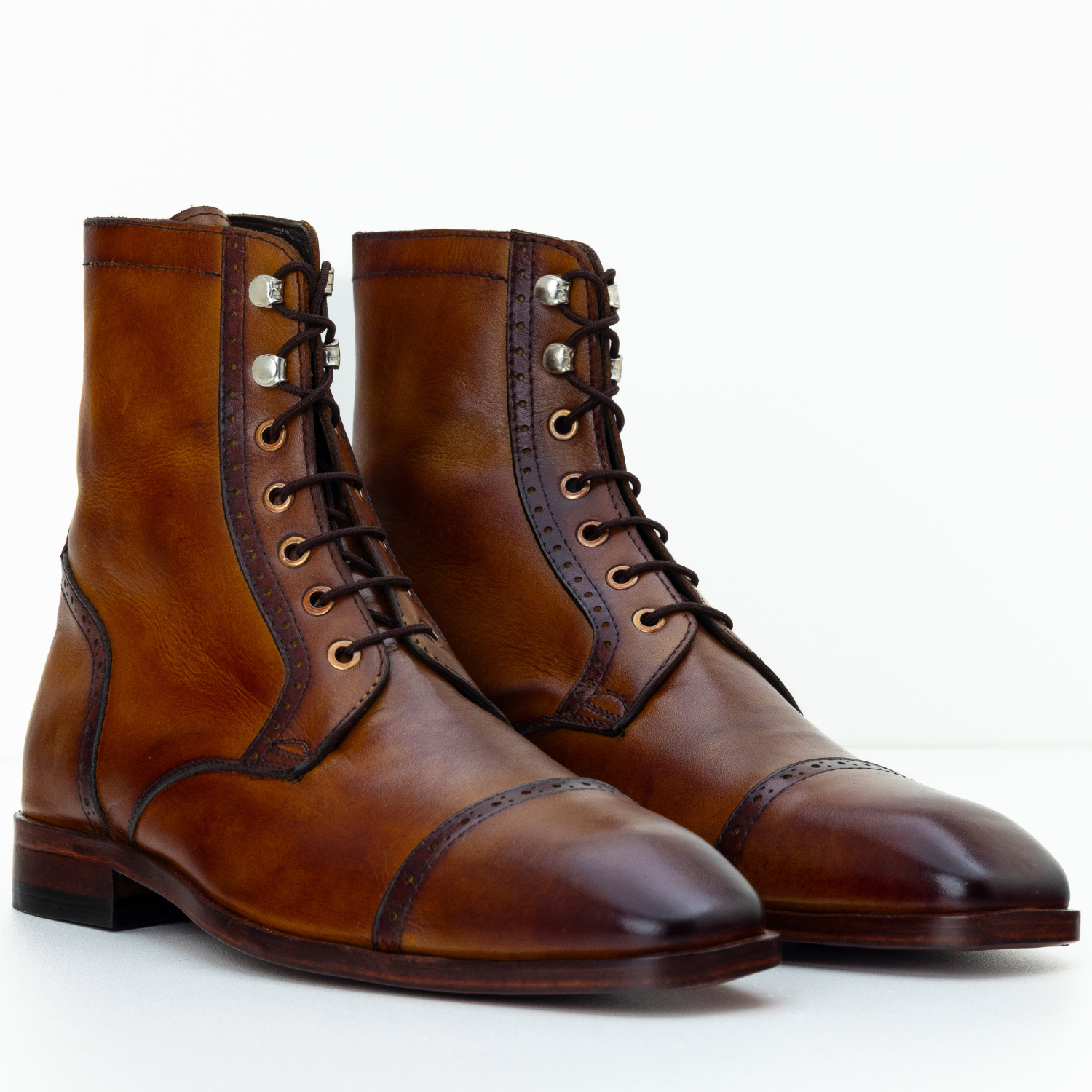 Pair of brown leather boots on a white background