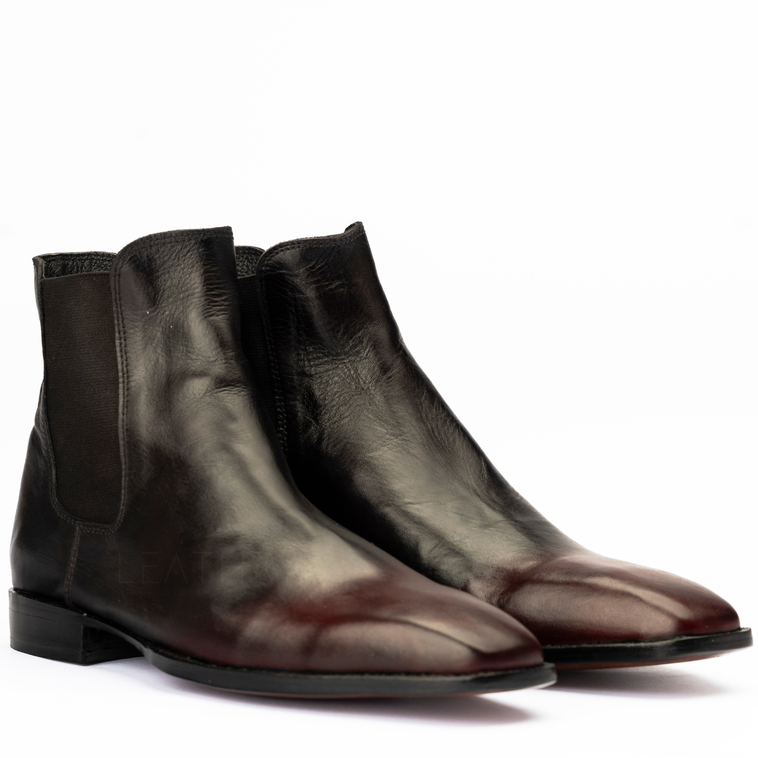 Pair of black leather boots on a white background