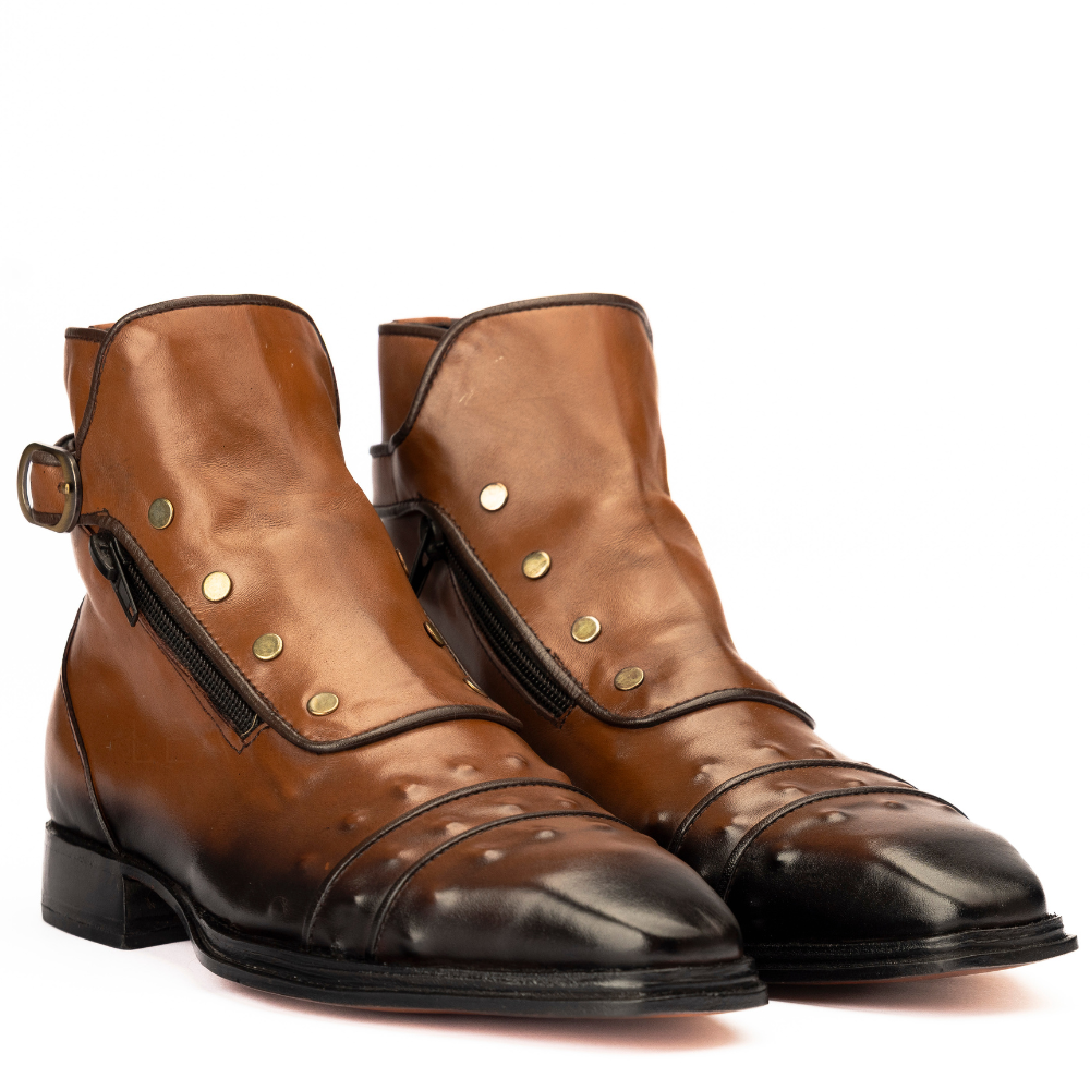 Pair of brown leather boots with gold studs on a white background