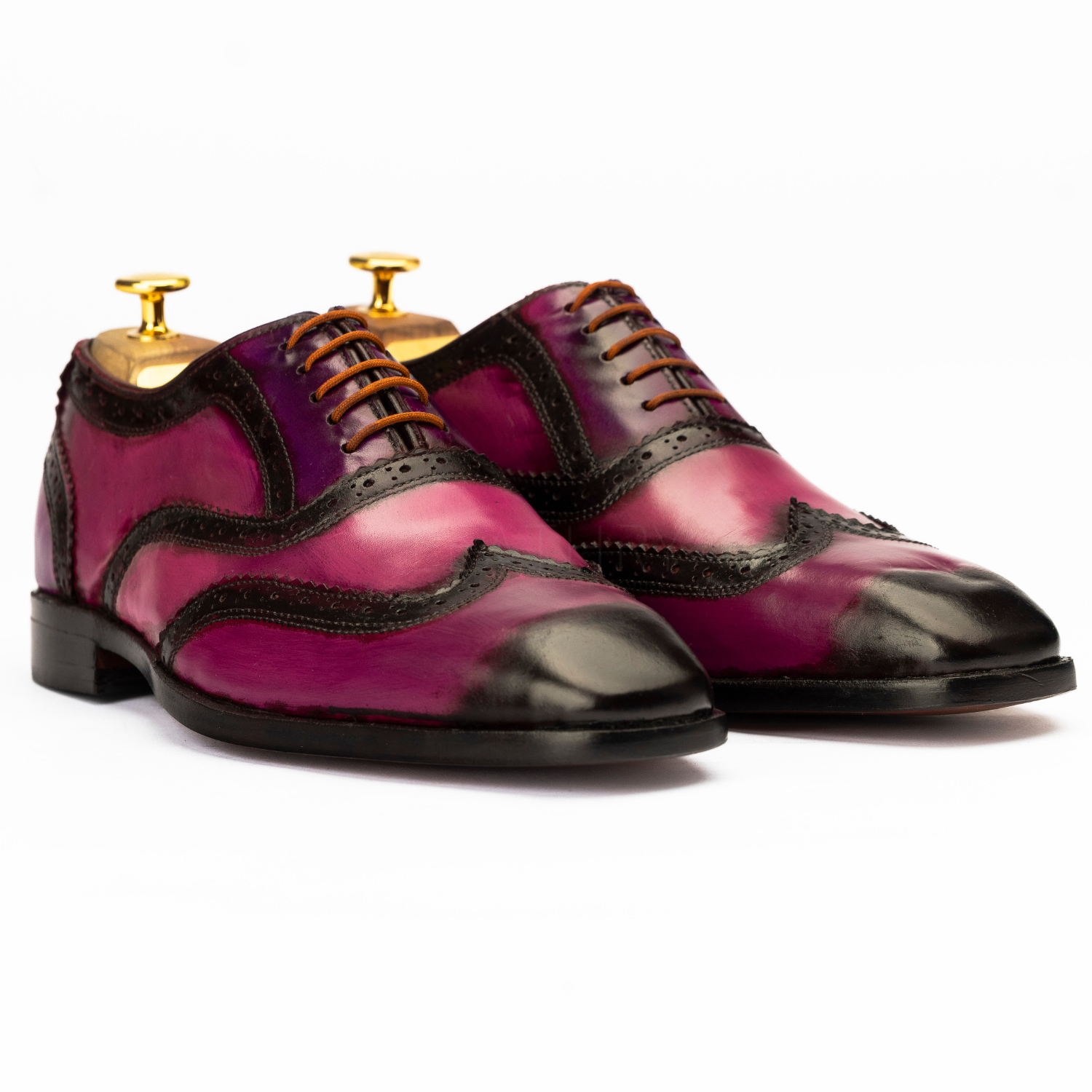 Pair of purple and black dress shoes on a white background