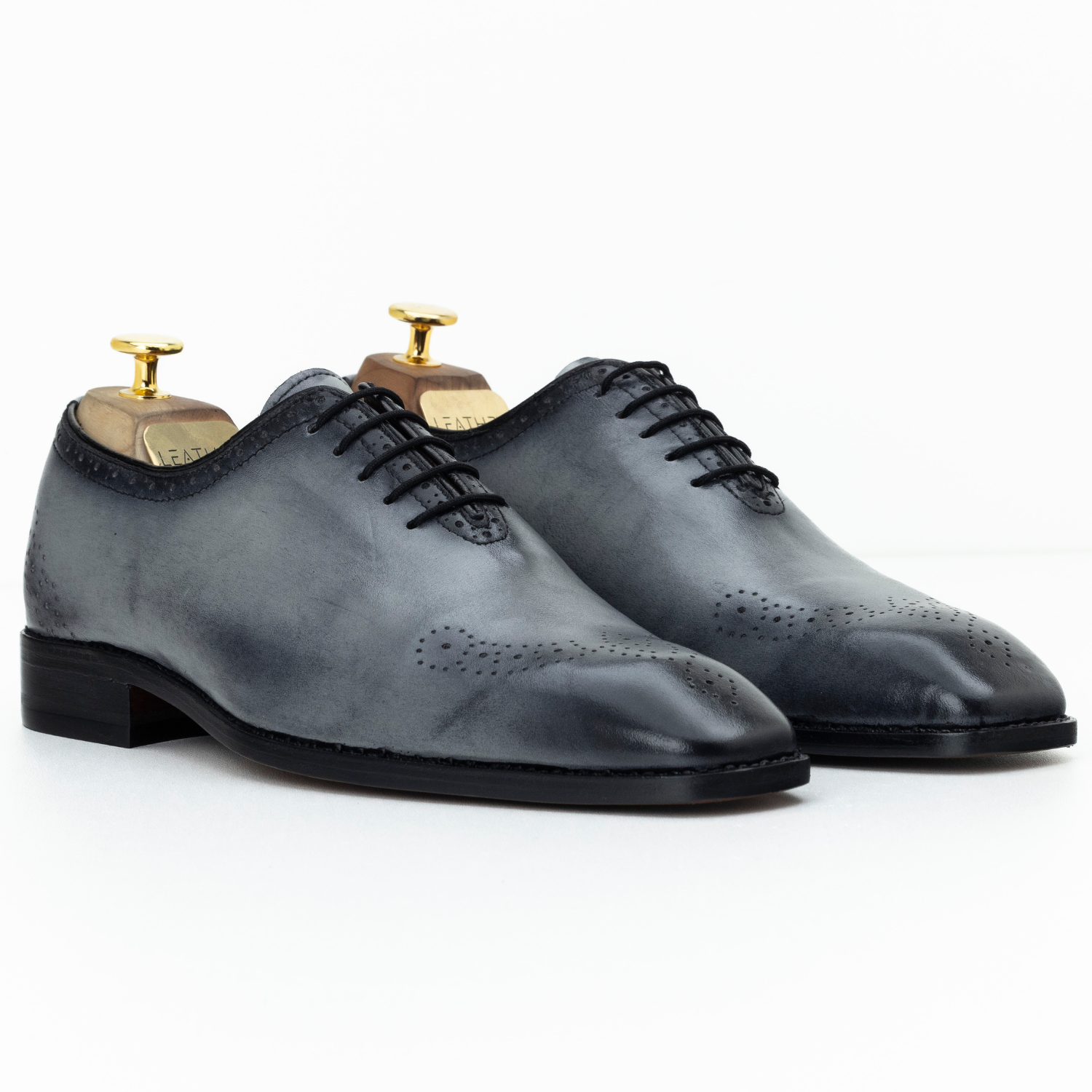 Pair of gray dress shoes on a white background