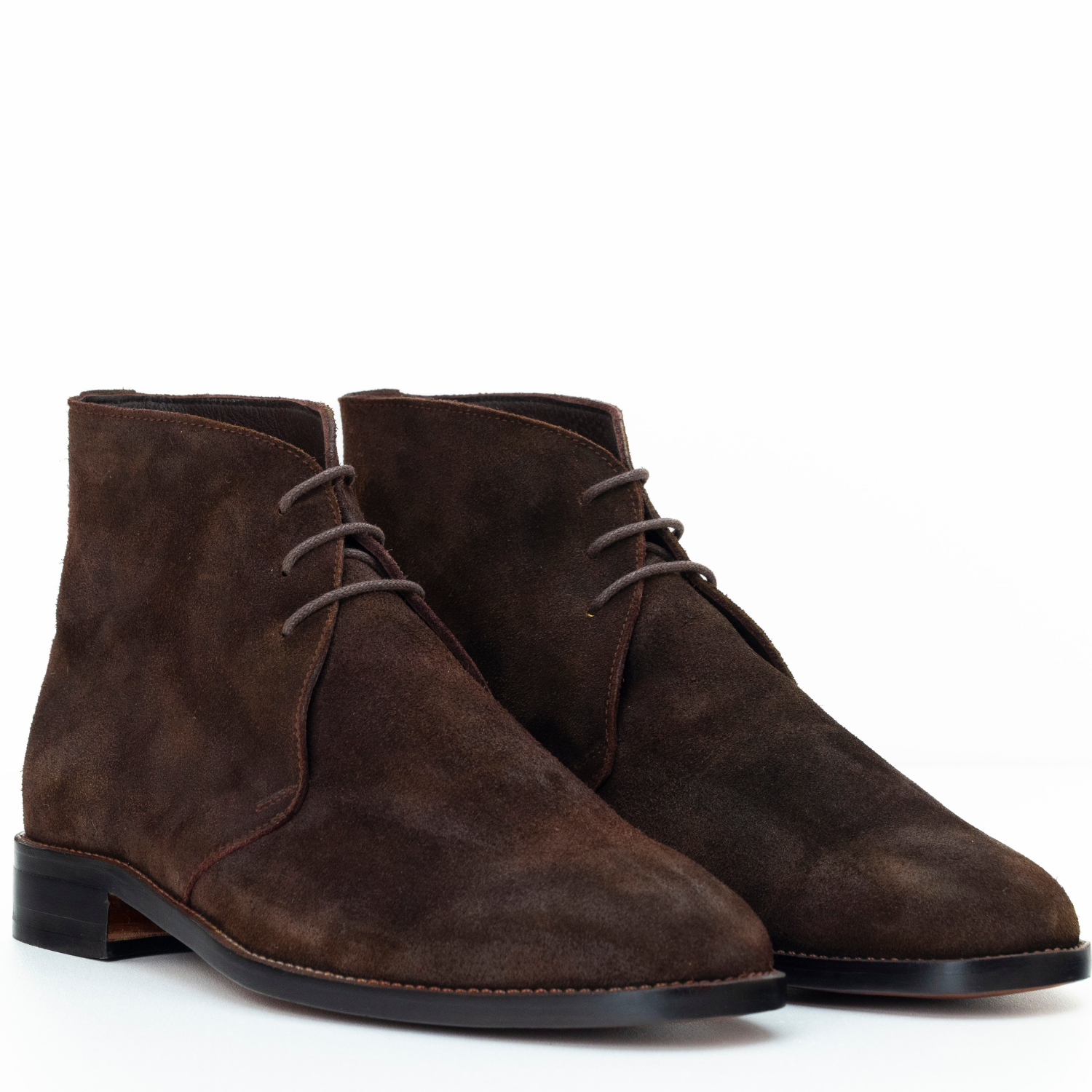 Pair of brown suede boots on a white background