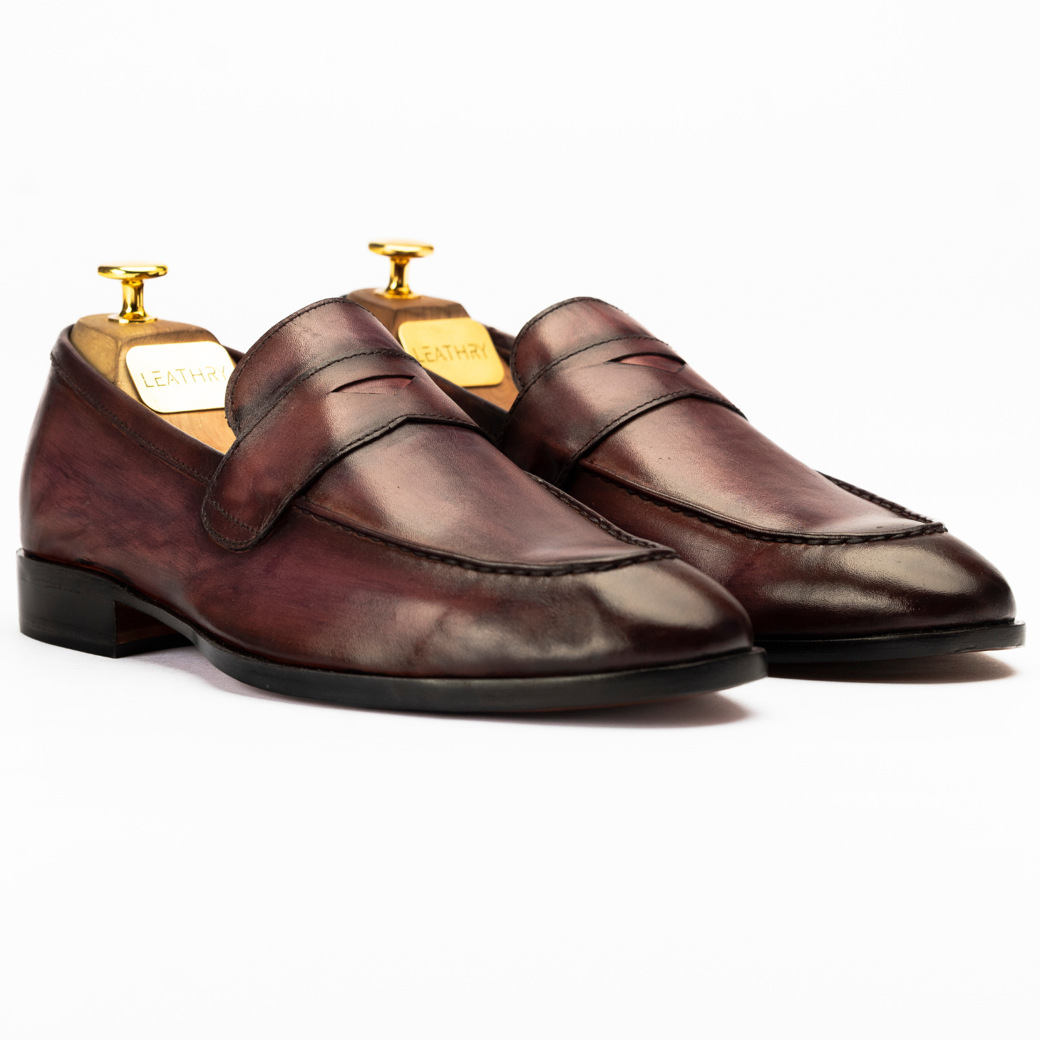 Pair of brown loafers on a white background