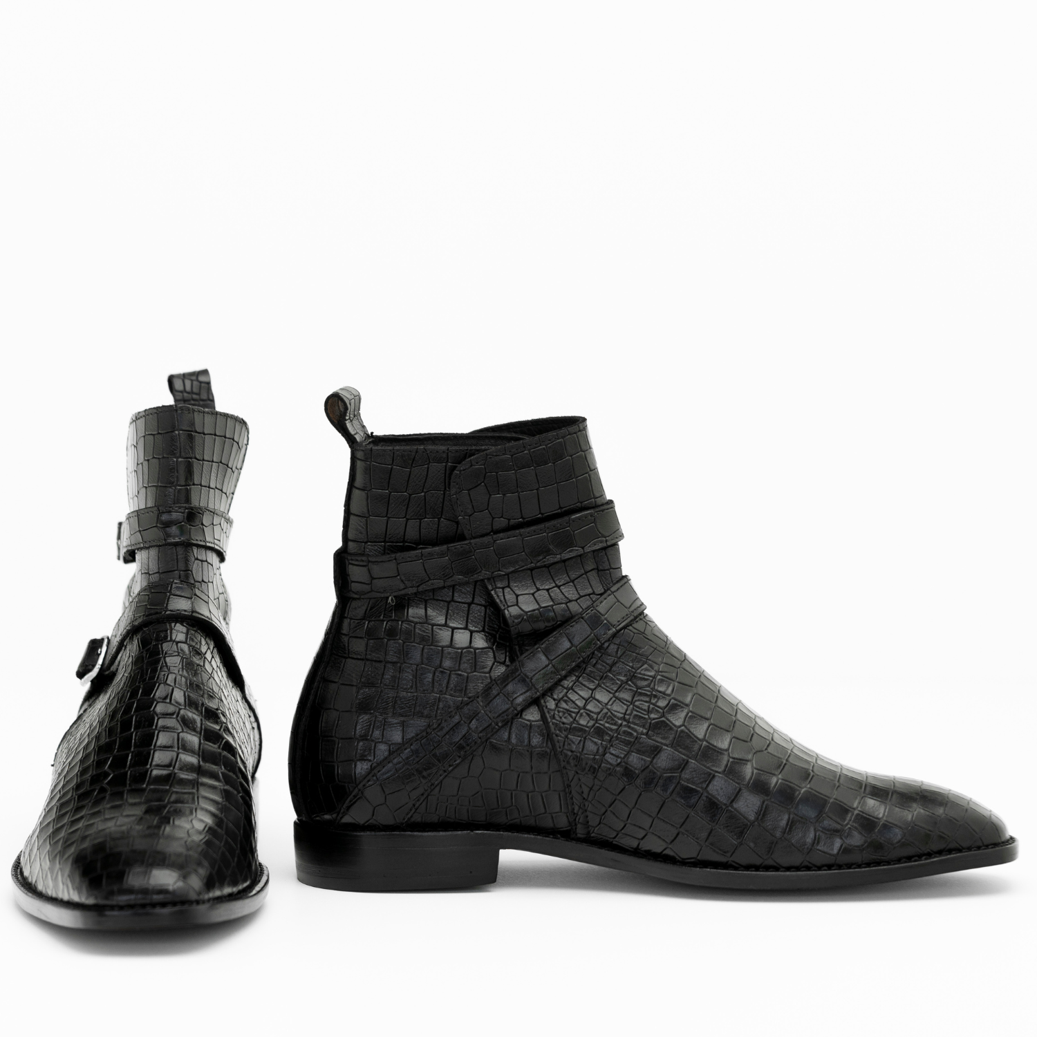 Black textured ankle boots on a white background