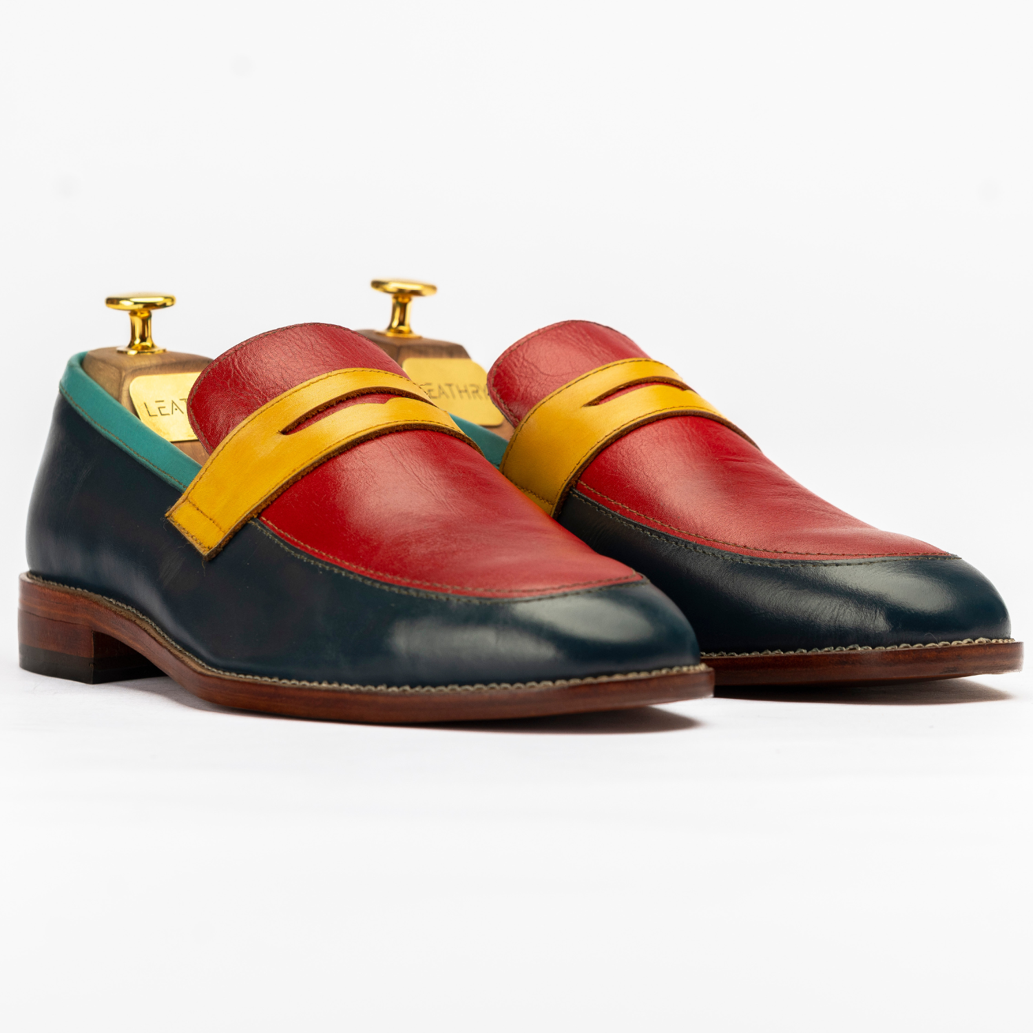 Colorful loafers with a yellow strap on a white background