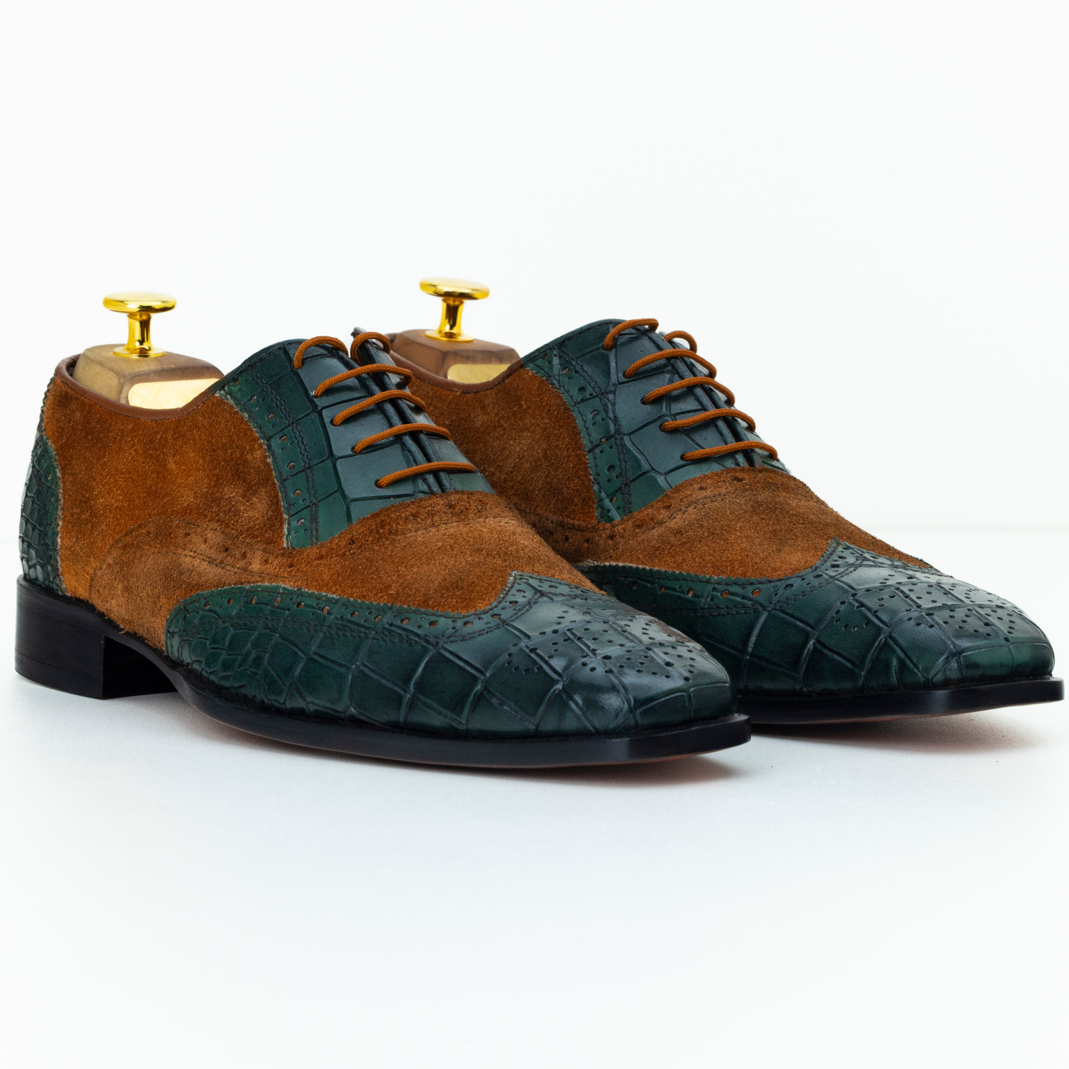 Pair of brown and green dress shoes on a white background