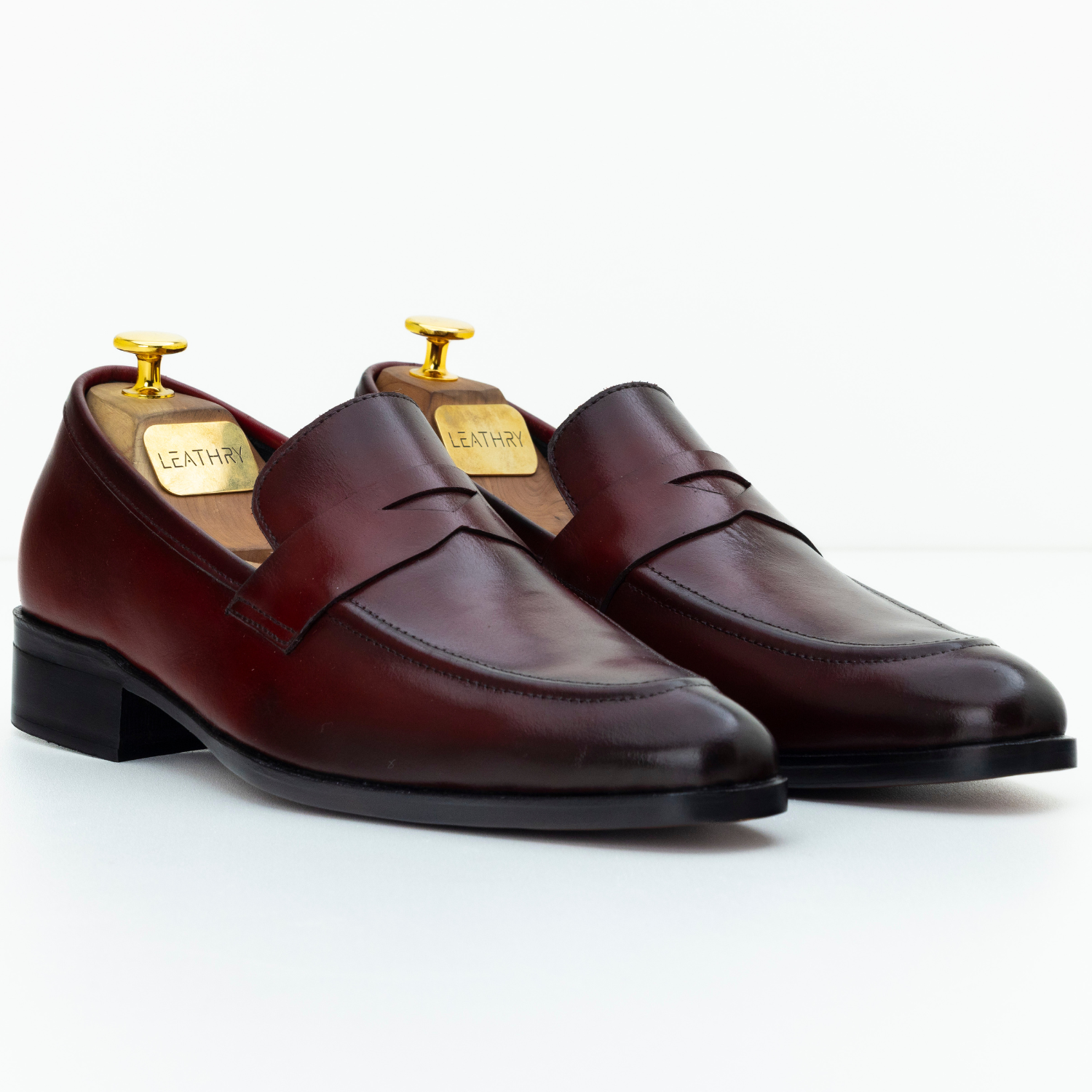 Pair of brown leather loafers on a white background