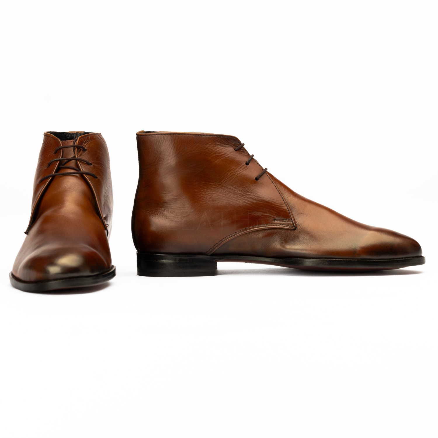 Pair of brown leather boots on a white background