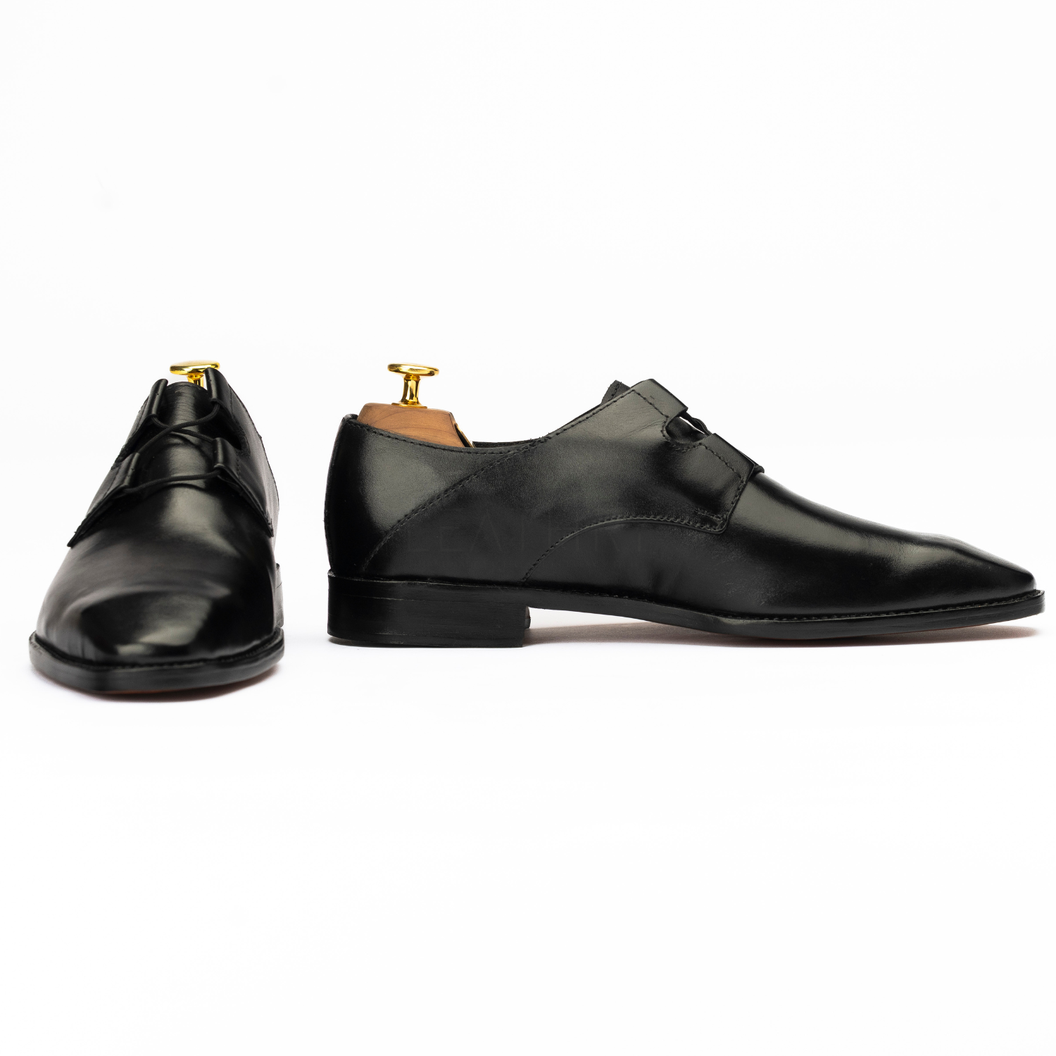 Pair of black dress shoes on a white background