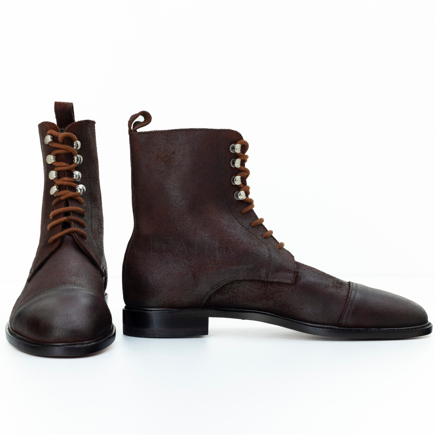 Pair of brown leather boots on a white background