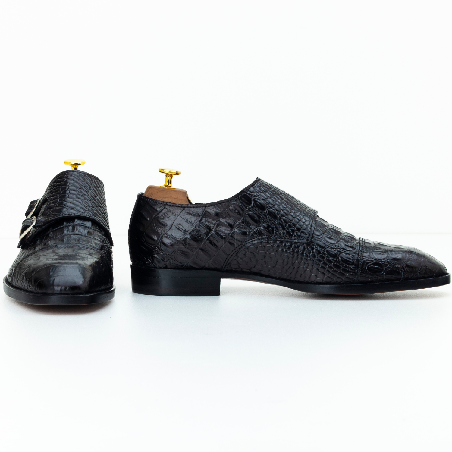 Pair of black textured dress shoes on a white background