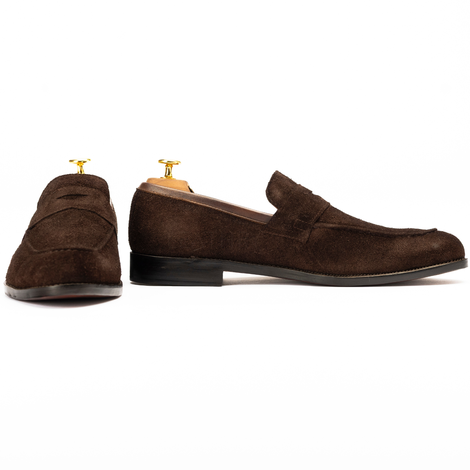 Brown suede loafers on a white background