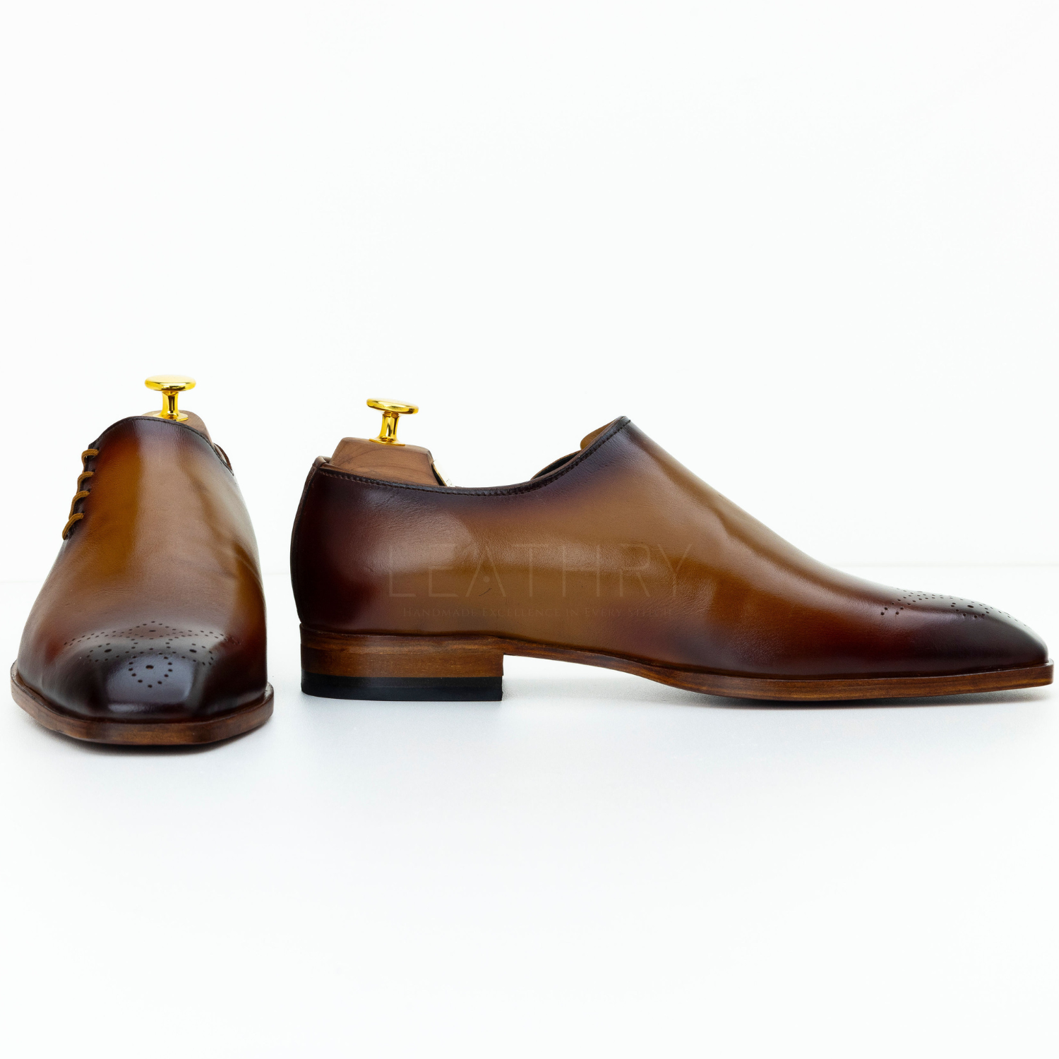 Pair of brown leather shoes on a white background