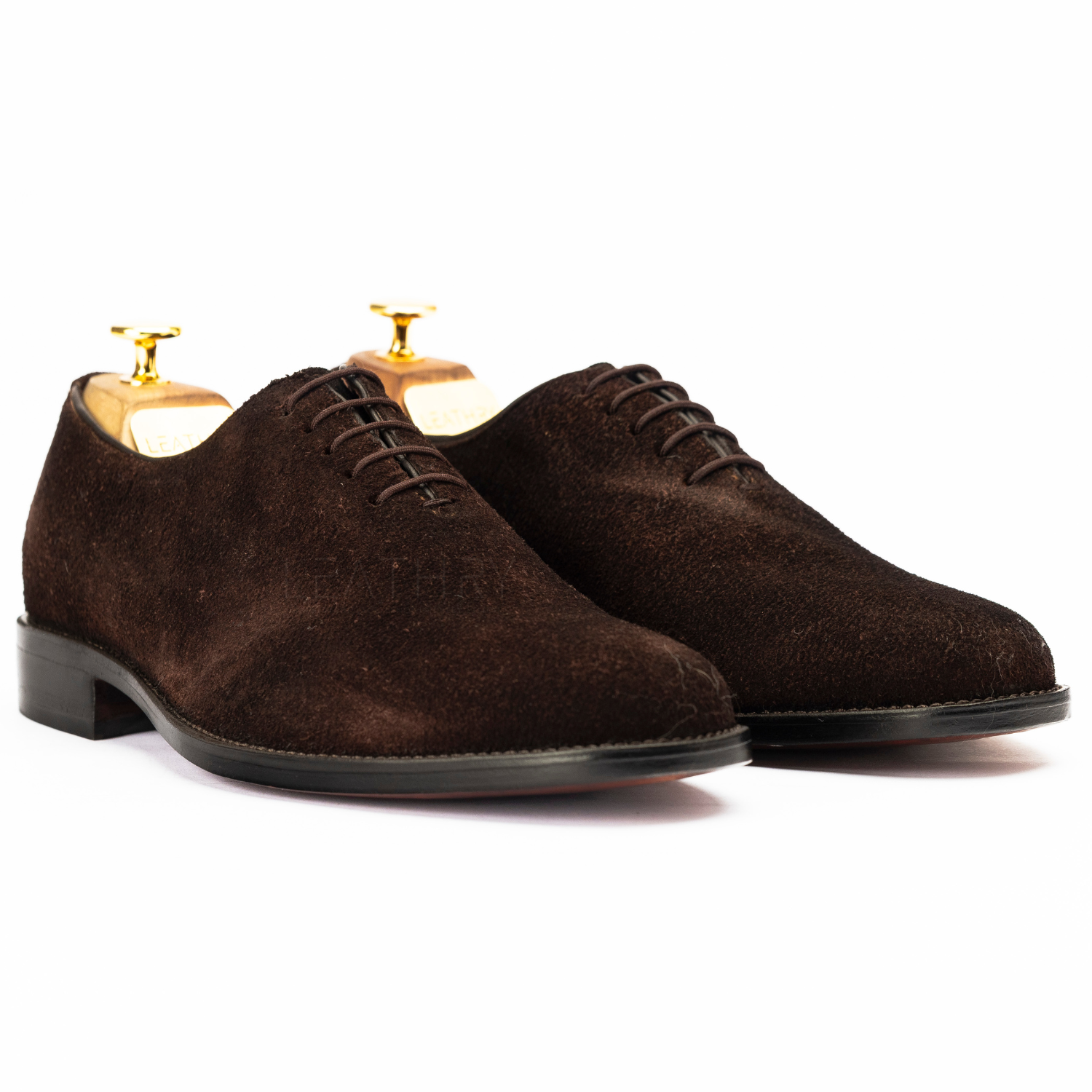 Pair of brown suede dress shoes on a white background