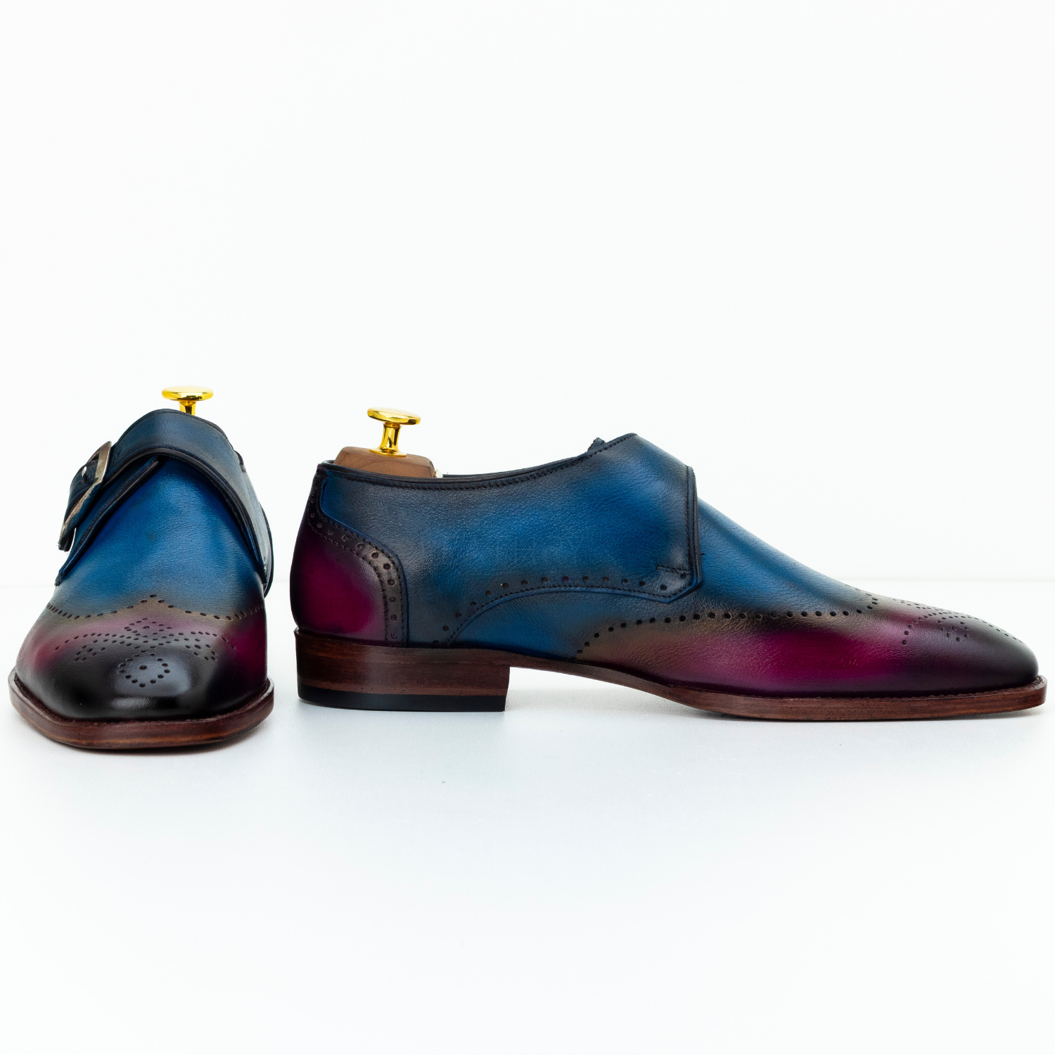 Pair of multicolored leather shoes with a gradient effect on a white background