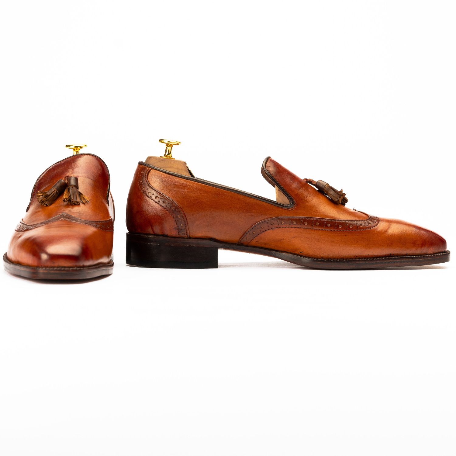 Pair of brown leather loafers on a white background