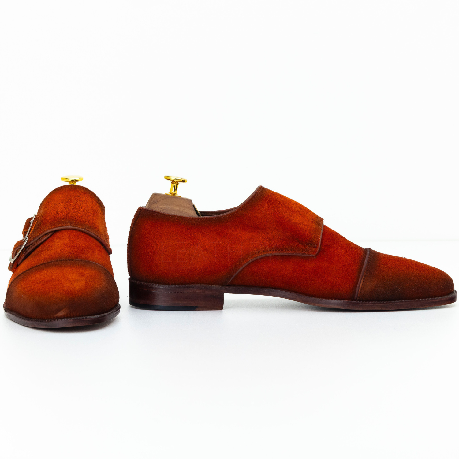 Pair of brown suede shoes on a white background