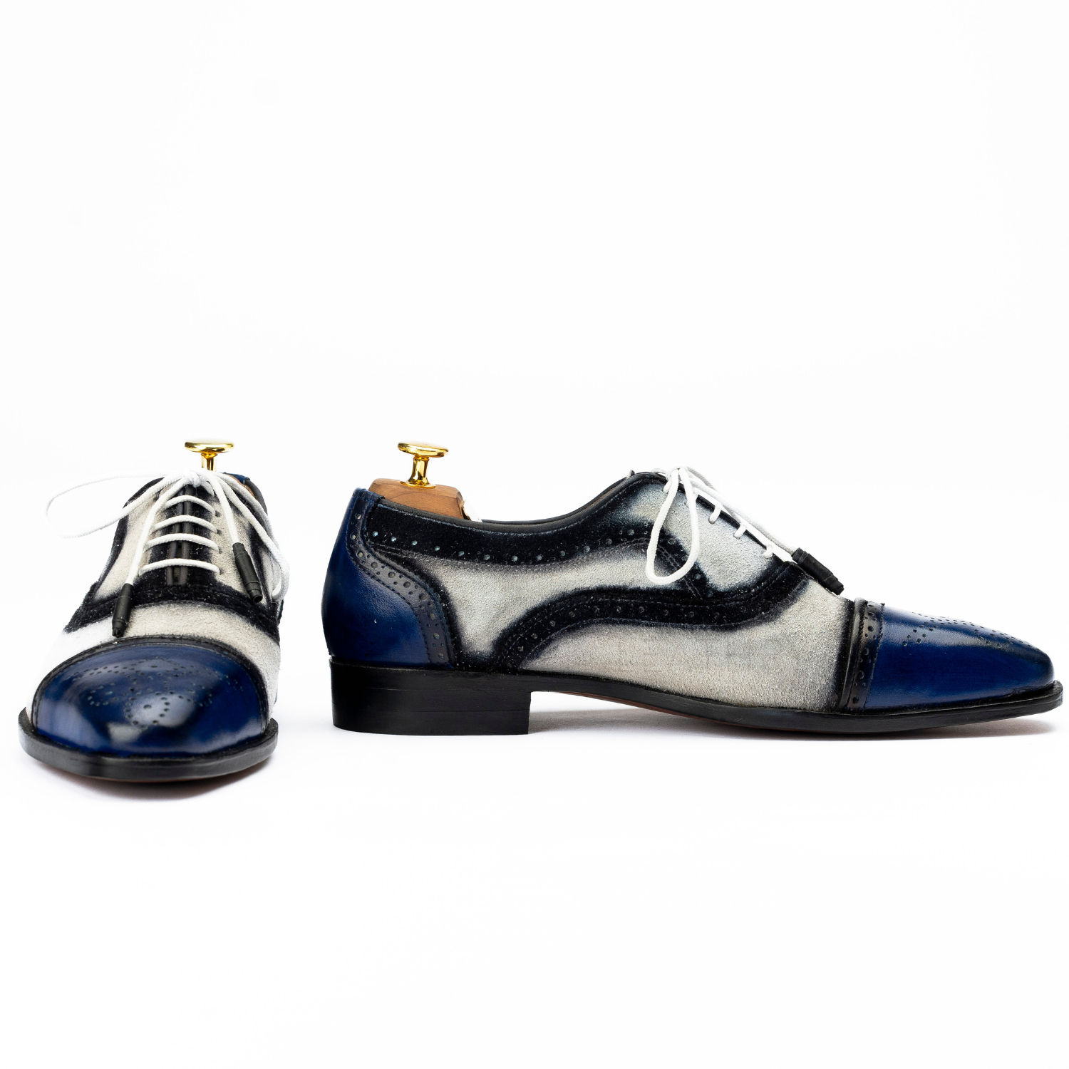 Pair of black and blue dress shoes on a white background
