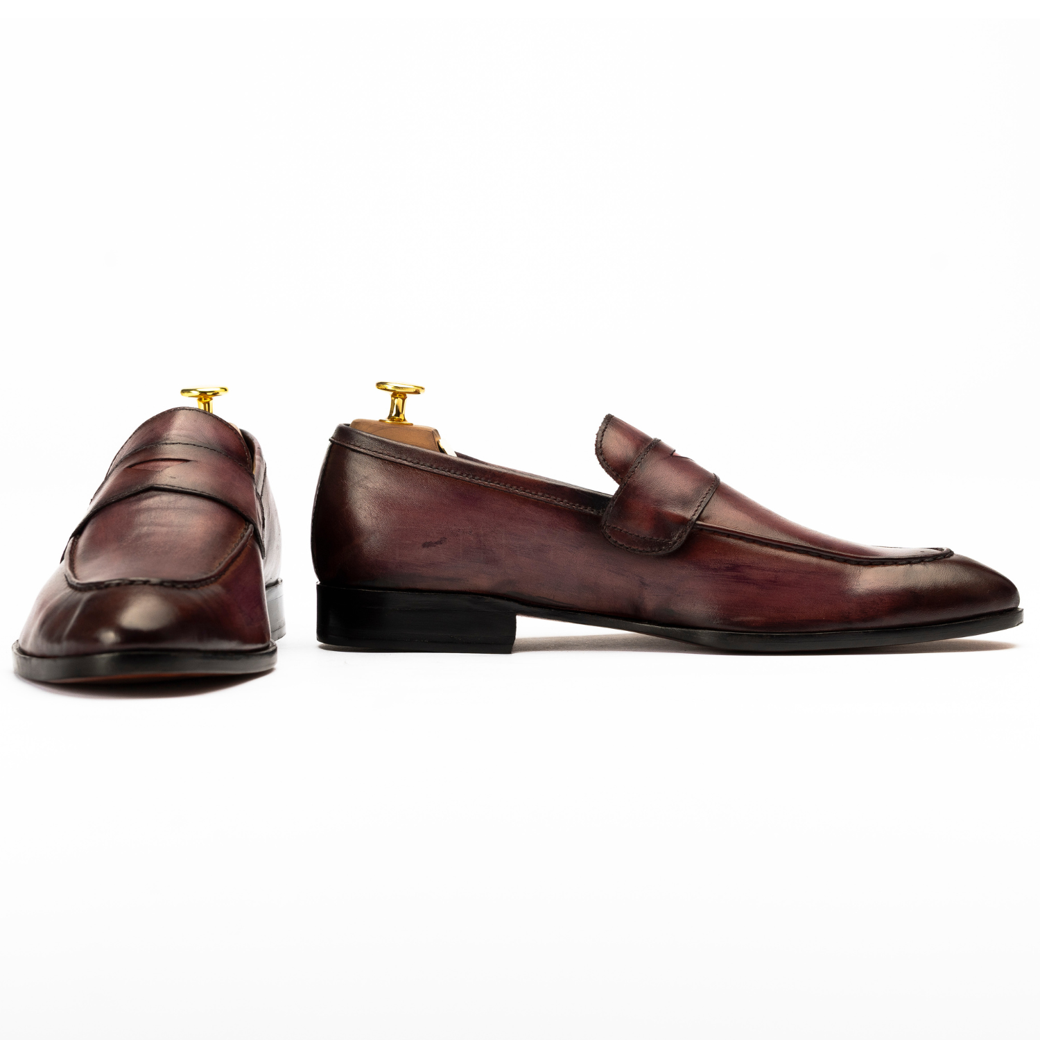Pair of brown leather loafers on a white background