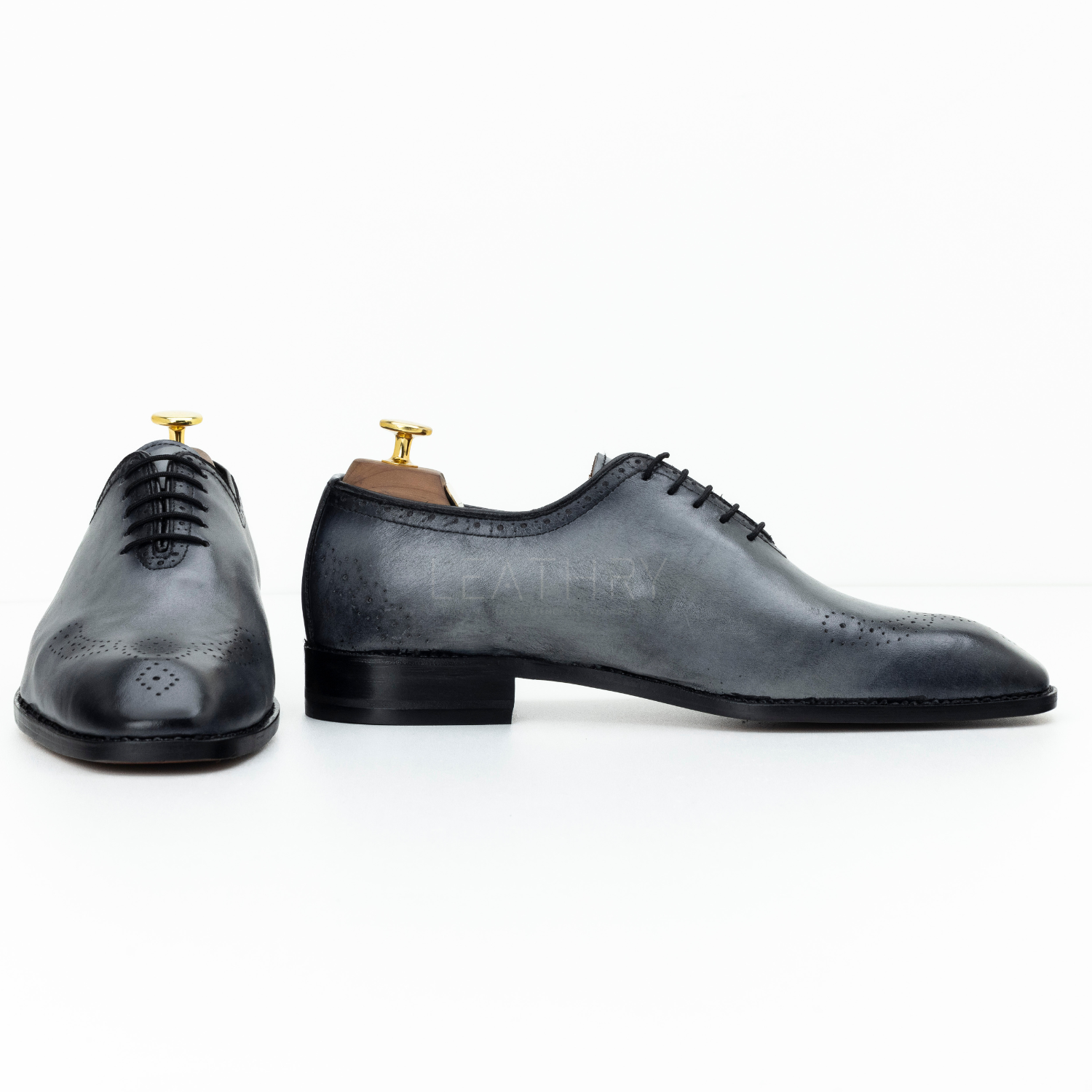Pair of black dress shoes on a white background