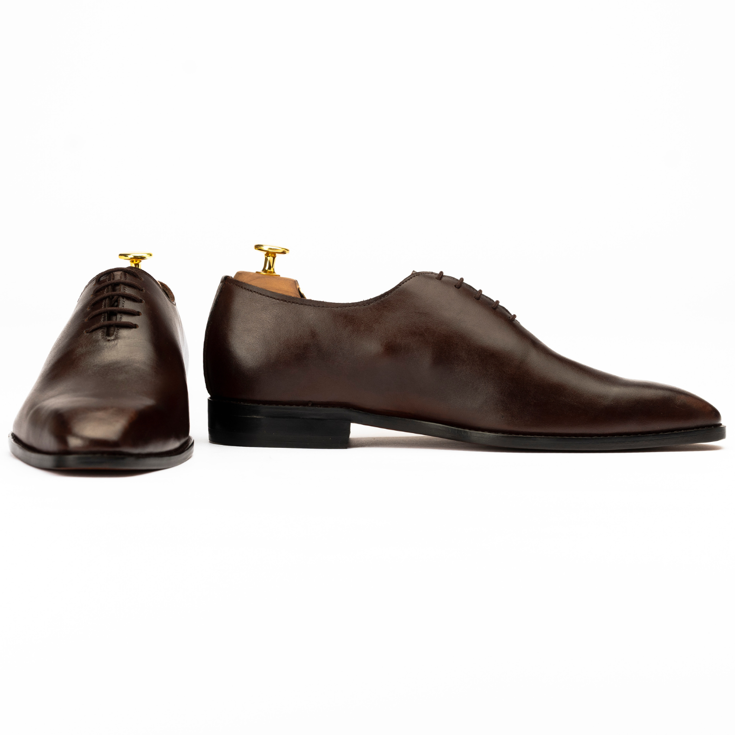 Pair of brown dress shoes on a white background
