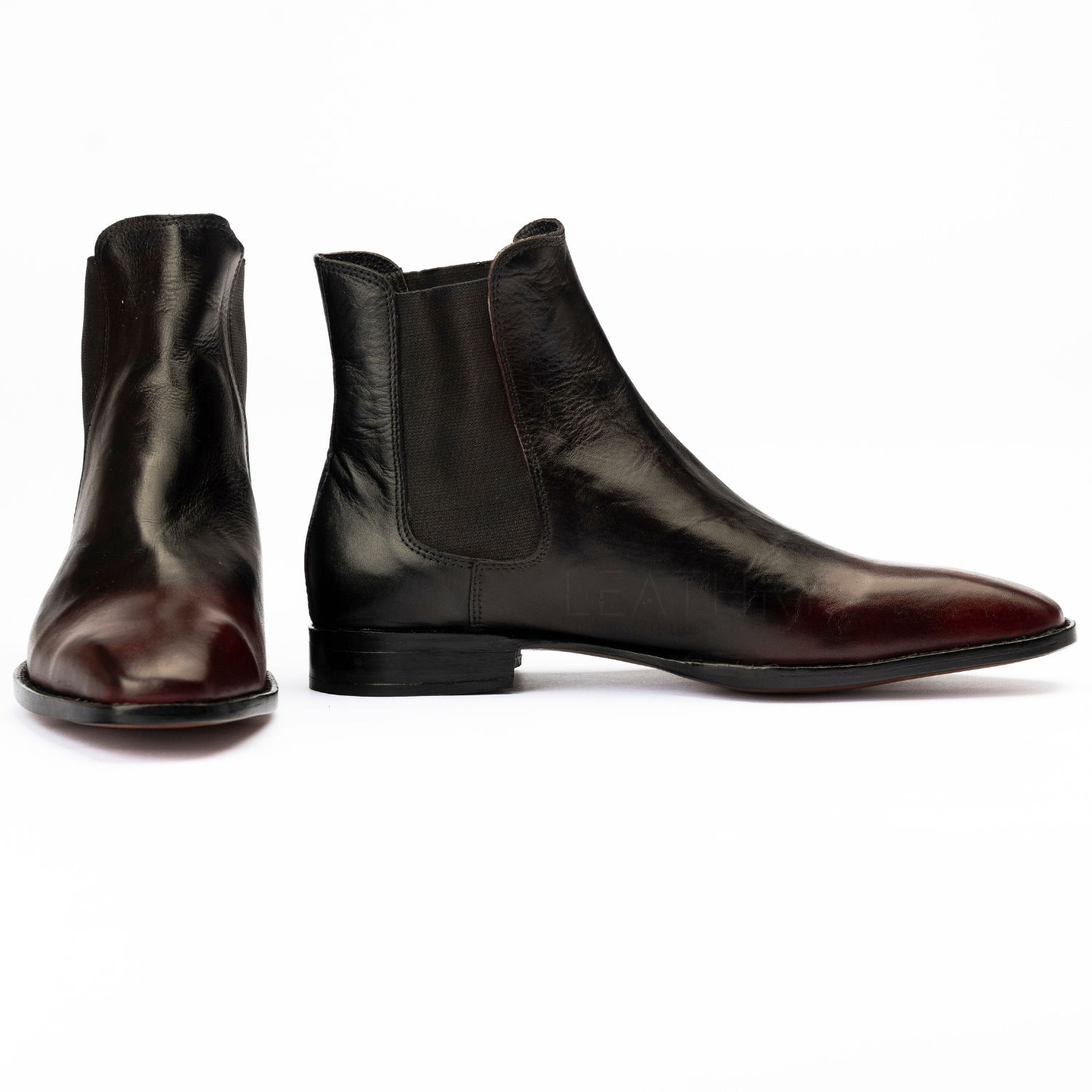 Pair of black leather ankle boots on a white background