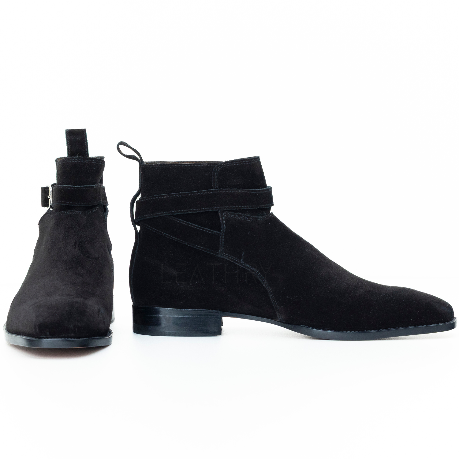 Pair of black suede ankle boots on a white background