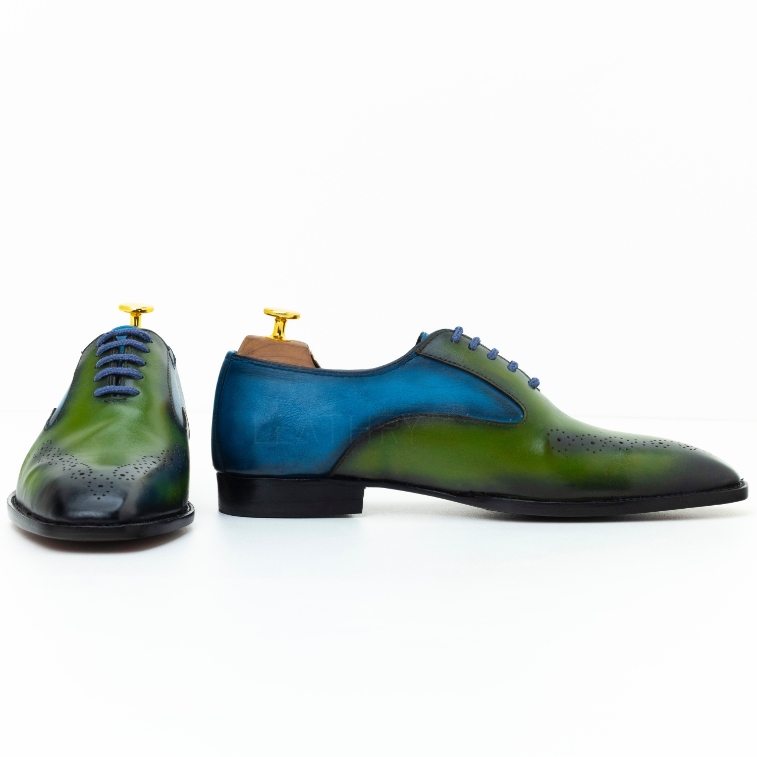Green and blue dress shoes on white background