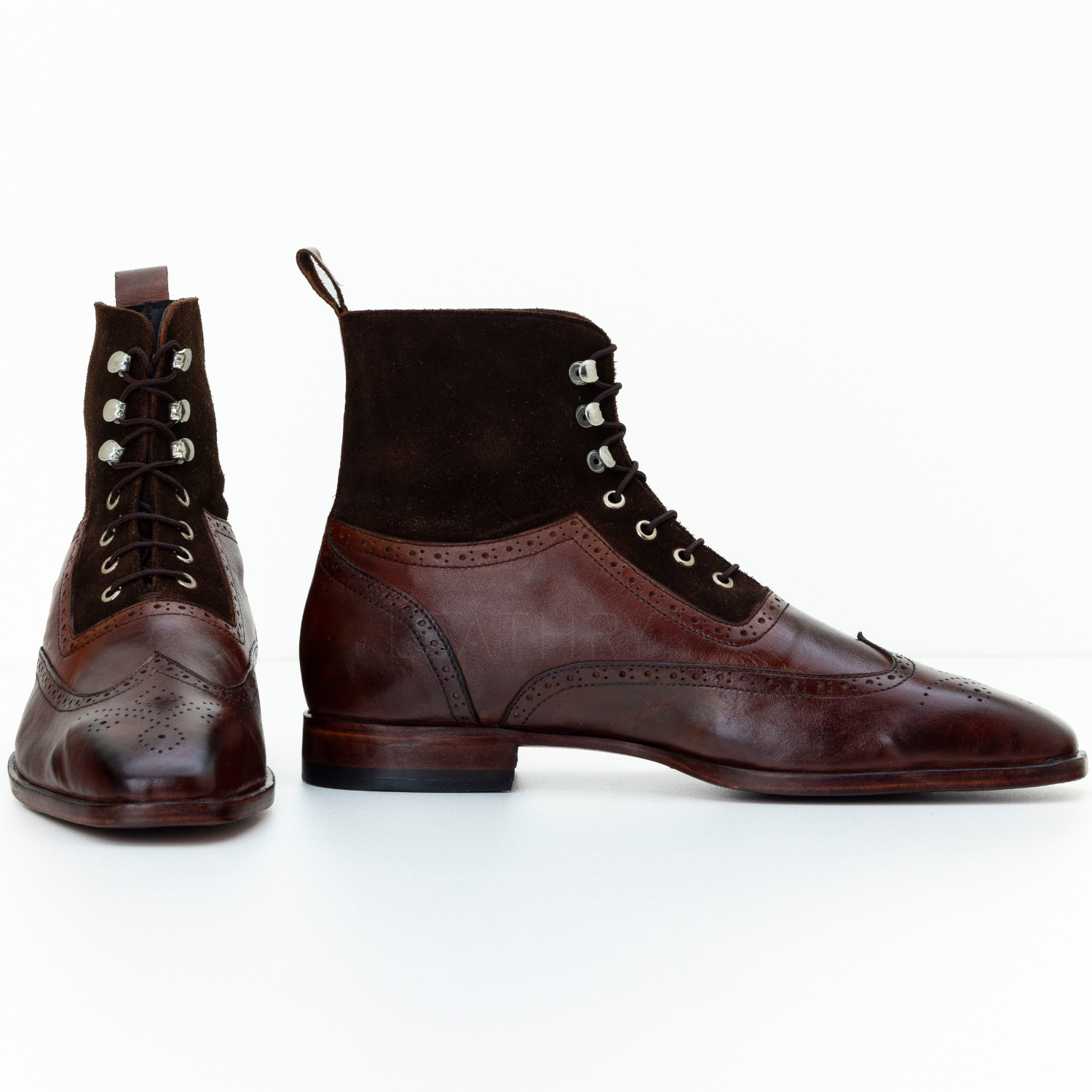 Pair of brown leather dress shoes on a white background