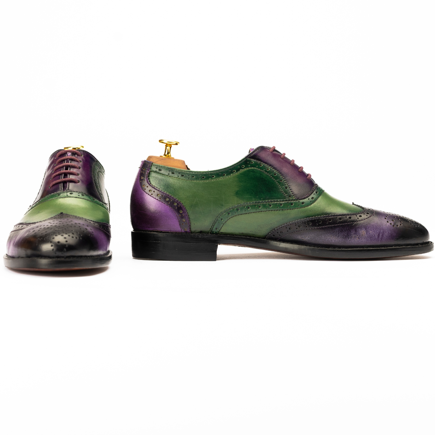 Green and purple dress shoes on a white background