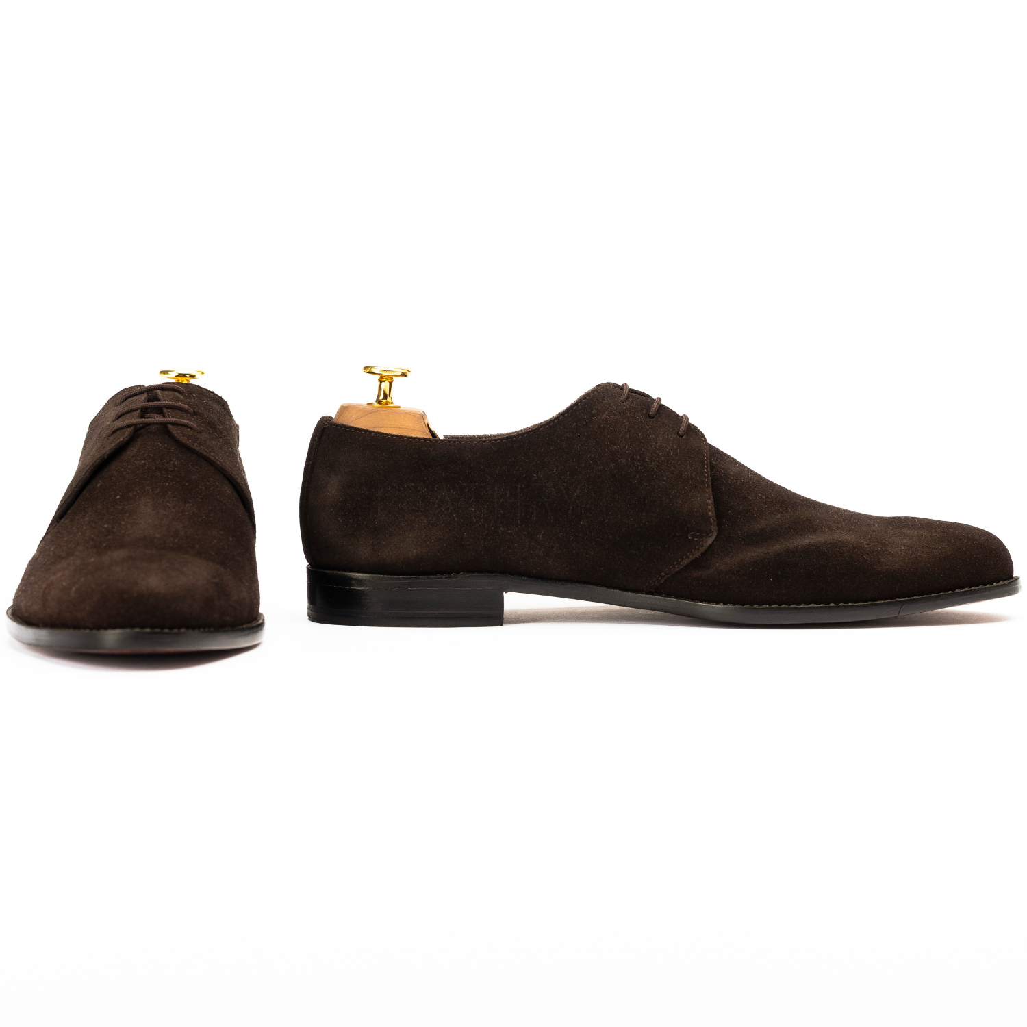 Brown suede dress shoes on a white background
