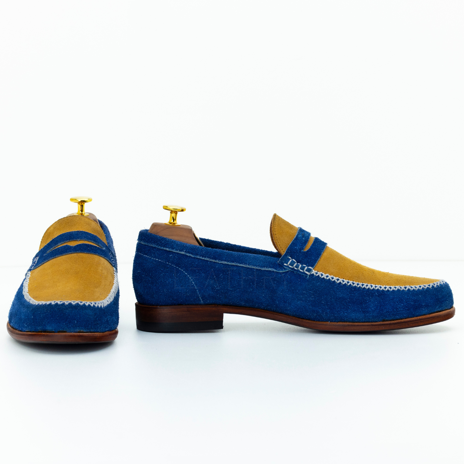 Pair of blue and yellow loafers on a white background