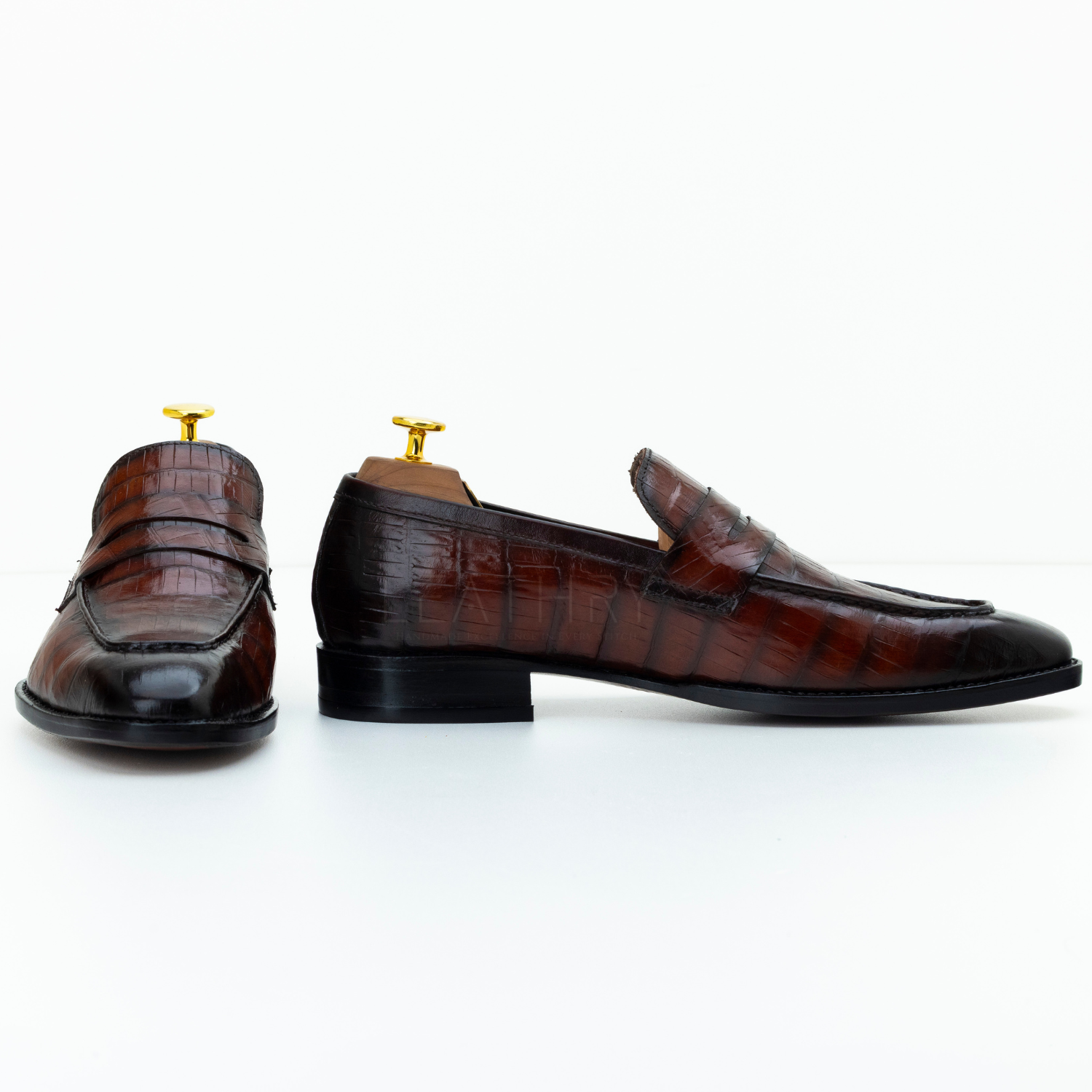Pair of brown leather loafers on a white background
