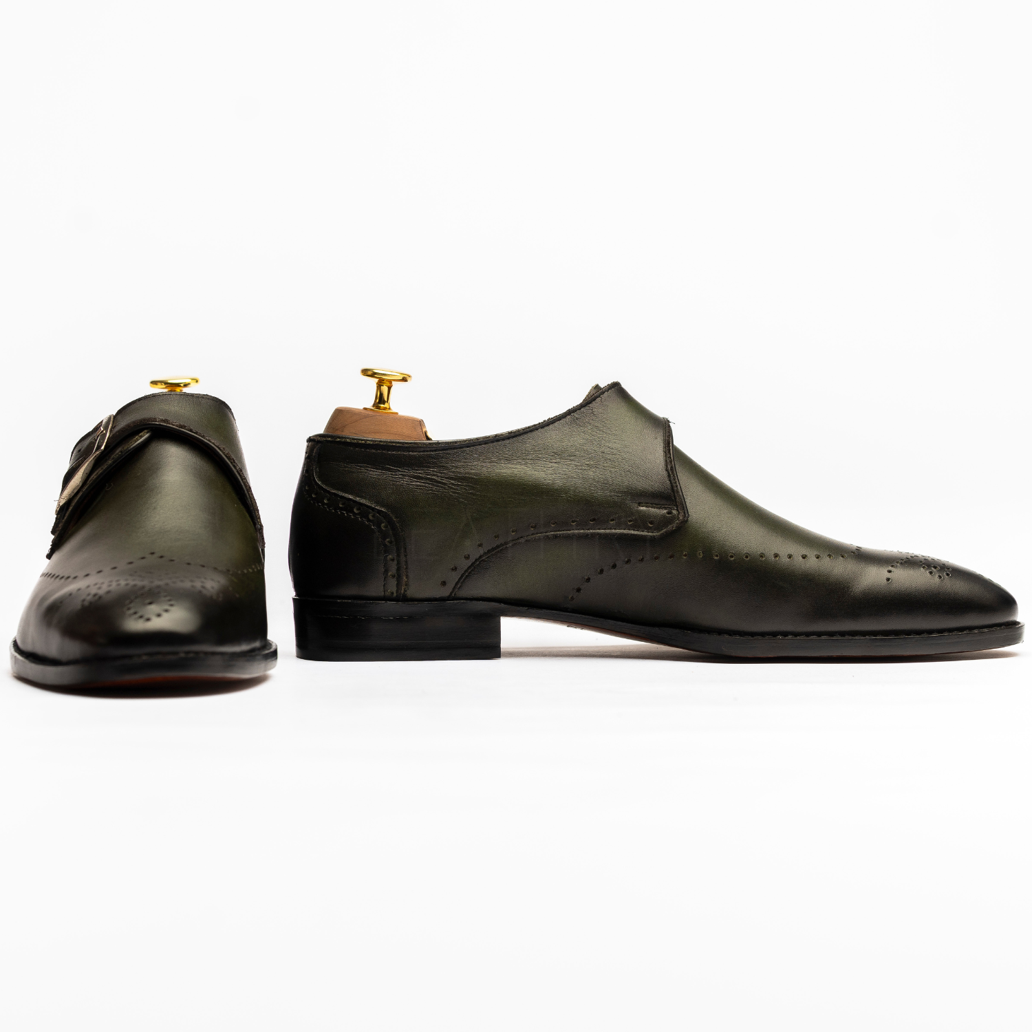 Pair of dark green dress shoes on a white background