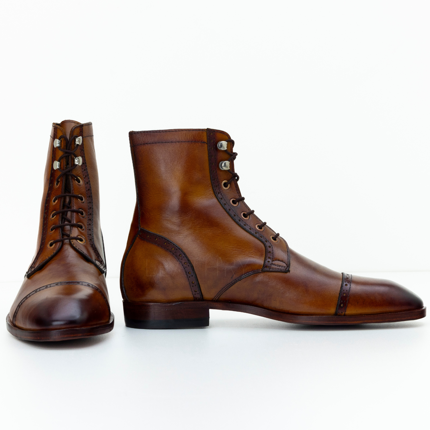 Pair of brown leather boots on a white background