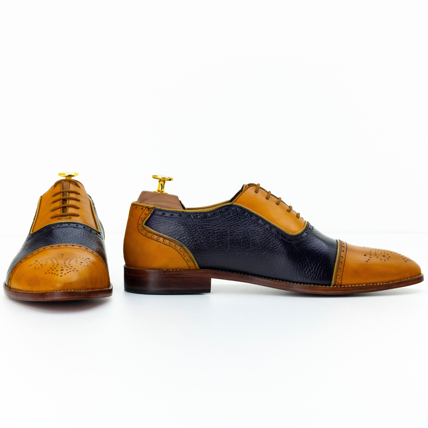 Brown and black leather dress shoes on a white background