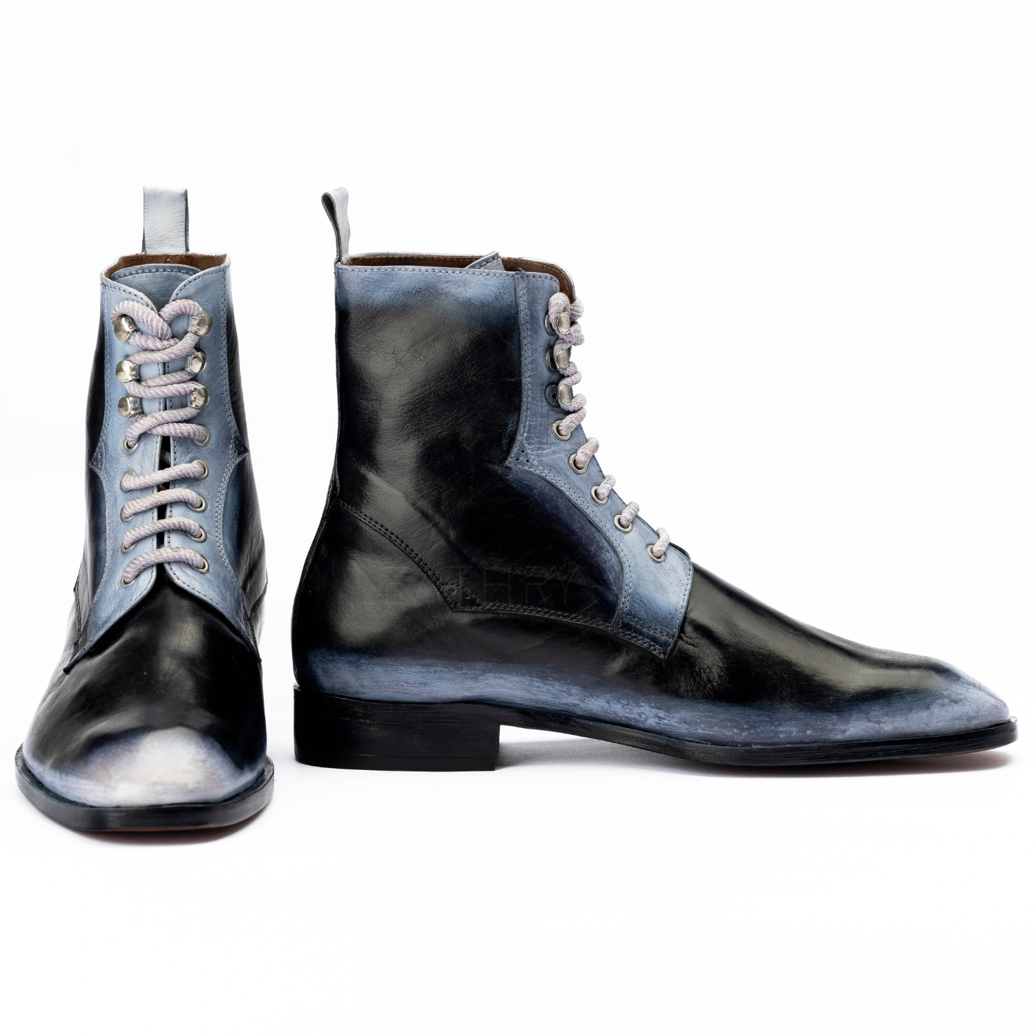 Pair of black and blue leather boots on a white background