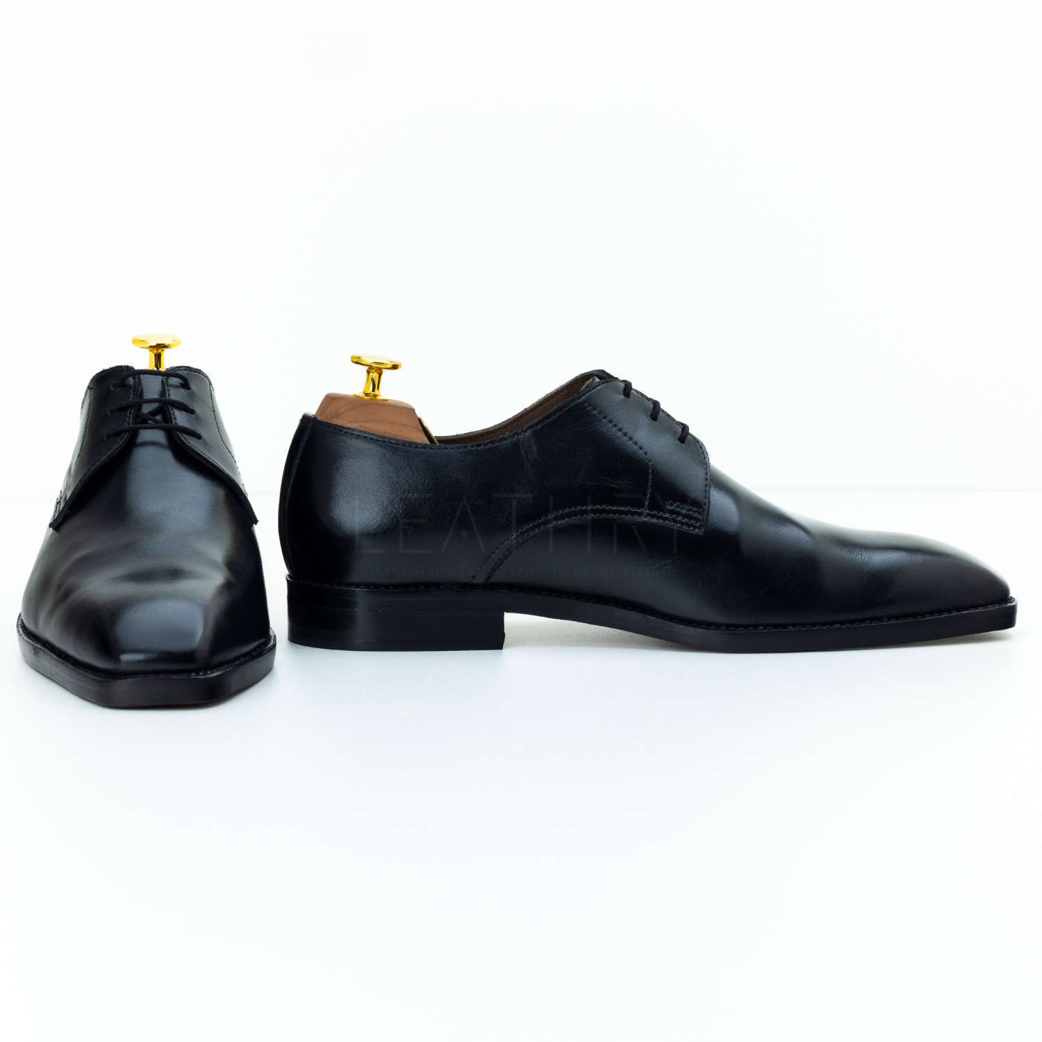 Pair of black dress shoes on a white background