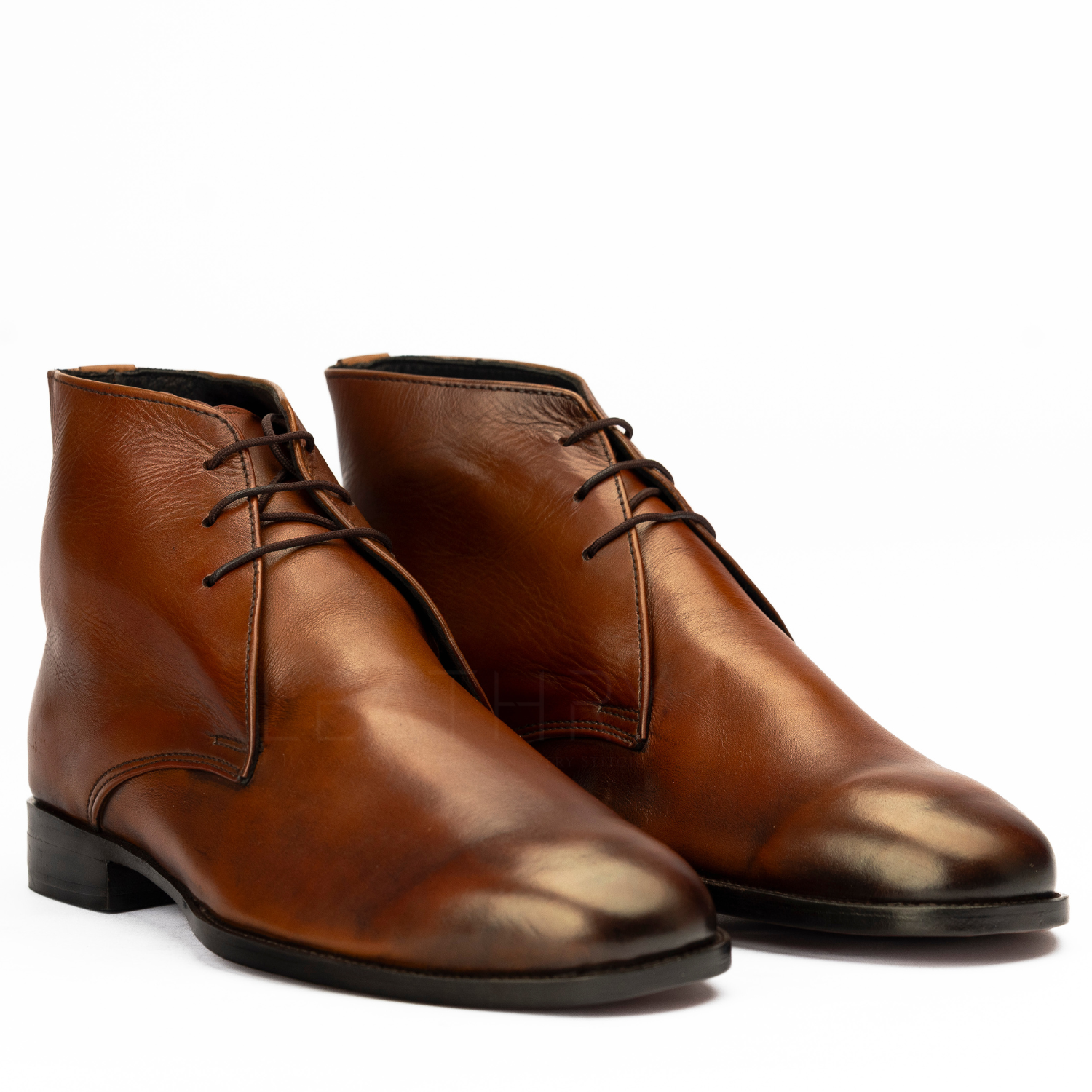 Pair of brown leather boots on a white background