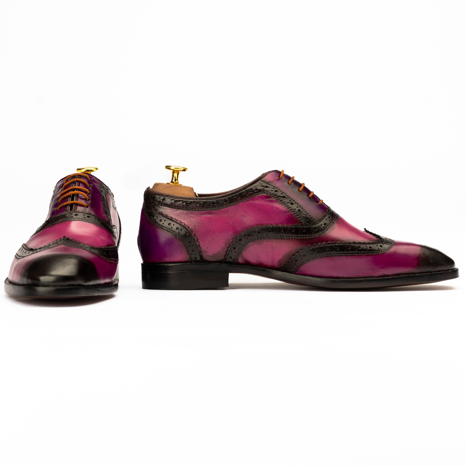 Pair of purple and black dress shoes on a white background