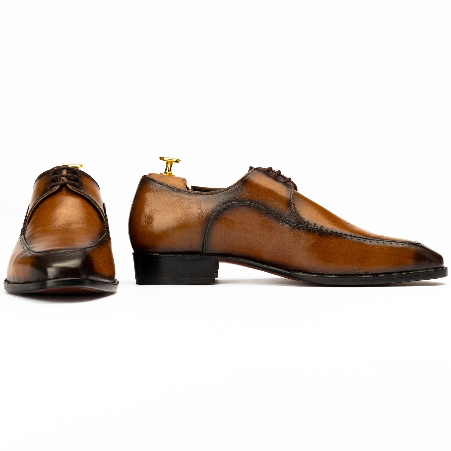 Pair of brown dress shoes on a white background