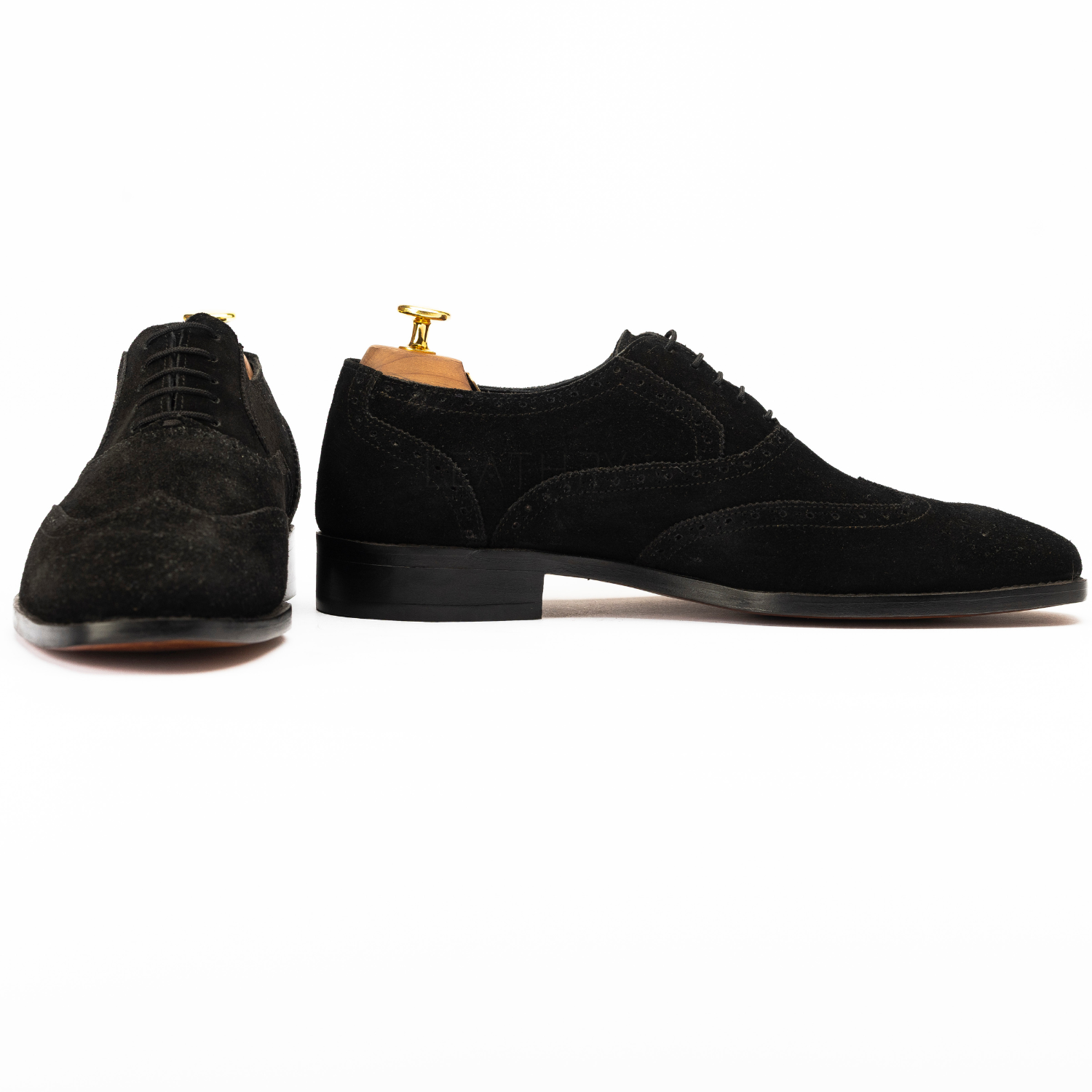 Black suede shoes on a white background