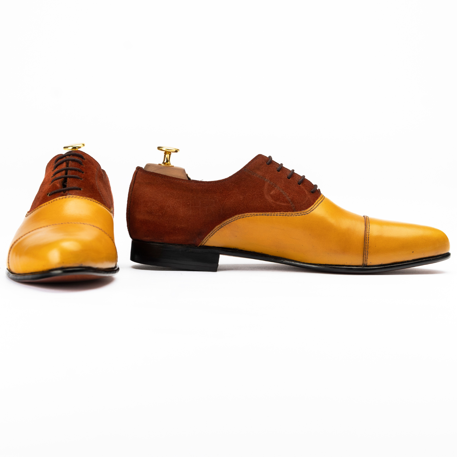 Brown and yellow dress shoes on a white background