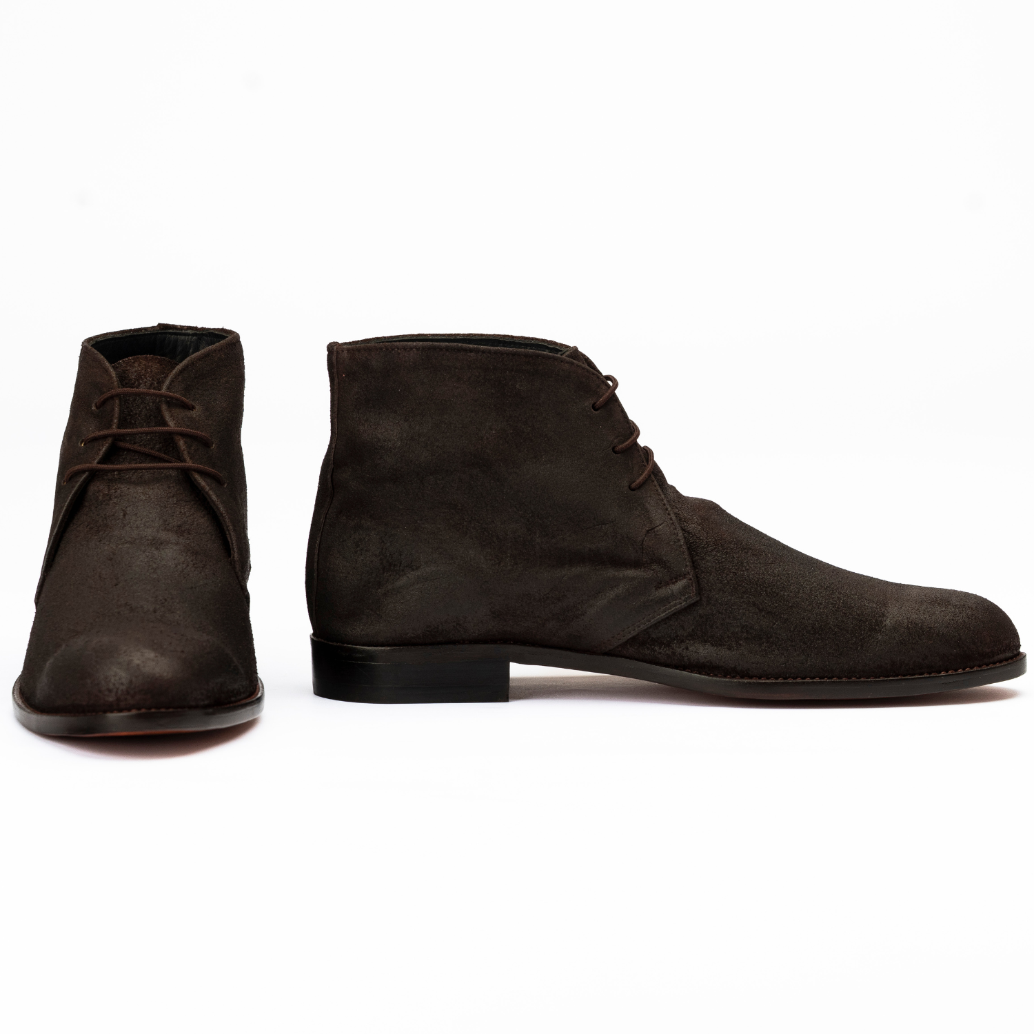 Pair of brown suede boots on a white background