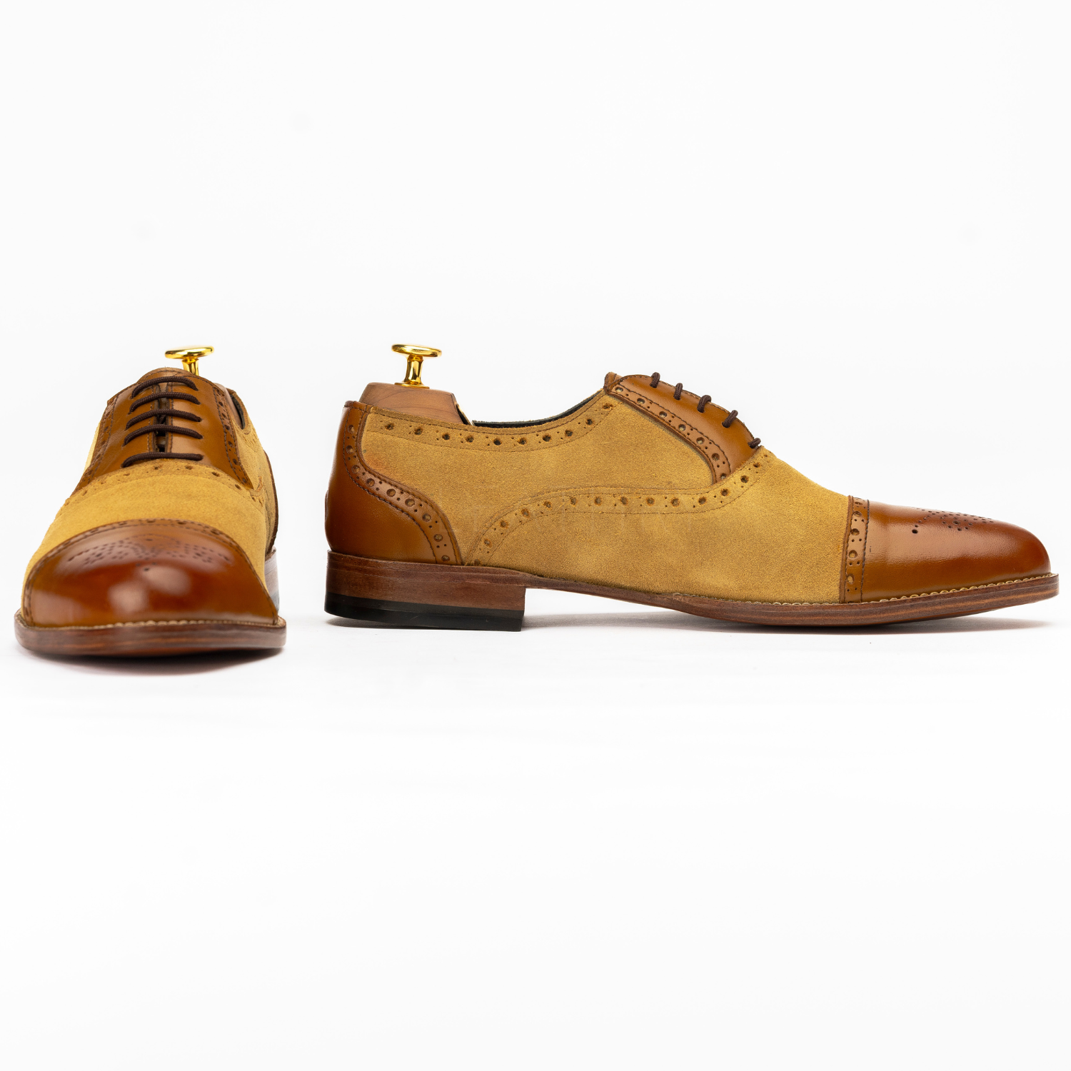 Pair of brown and tan dress shoes on a white background