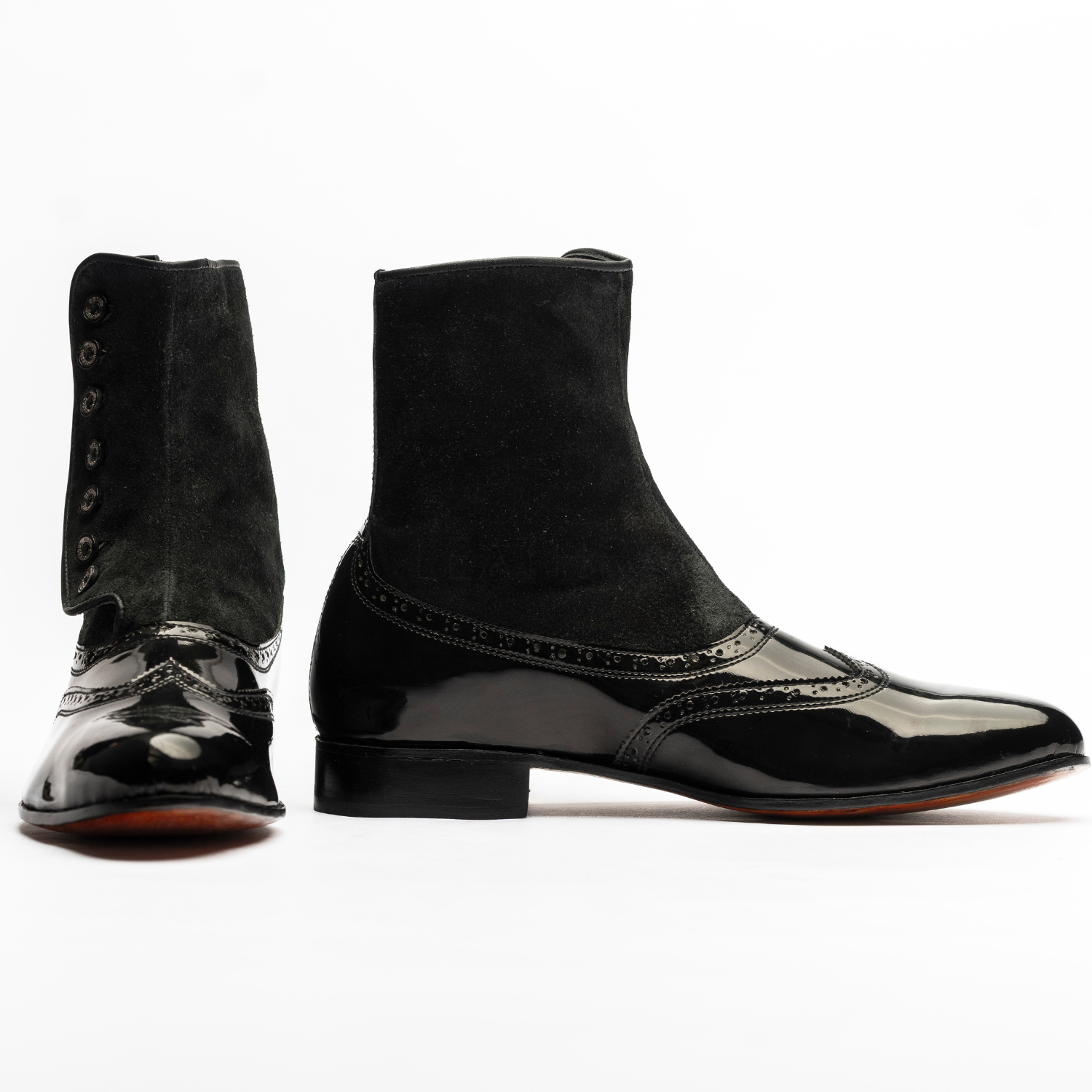 Black patent leather shoes with high gaiters on a white background