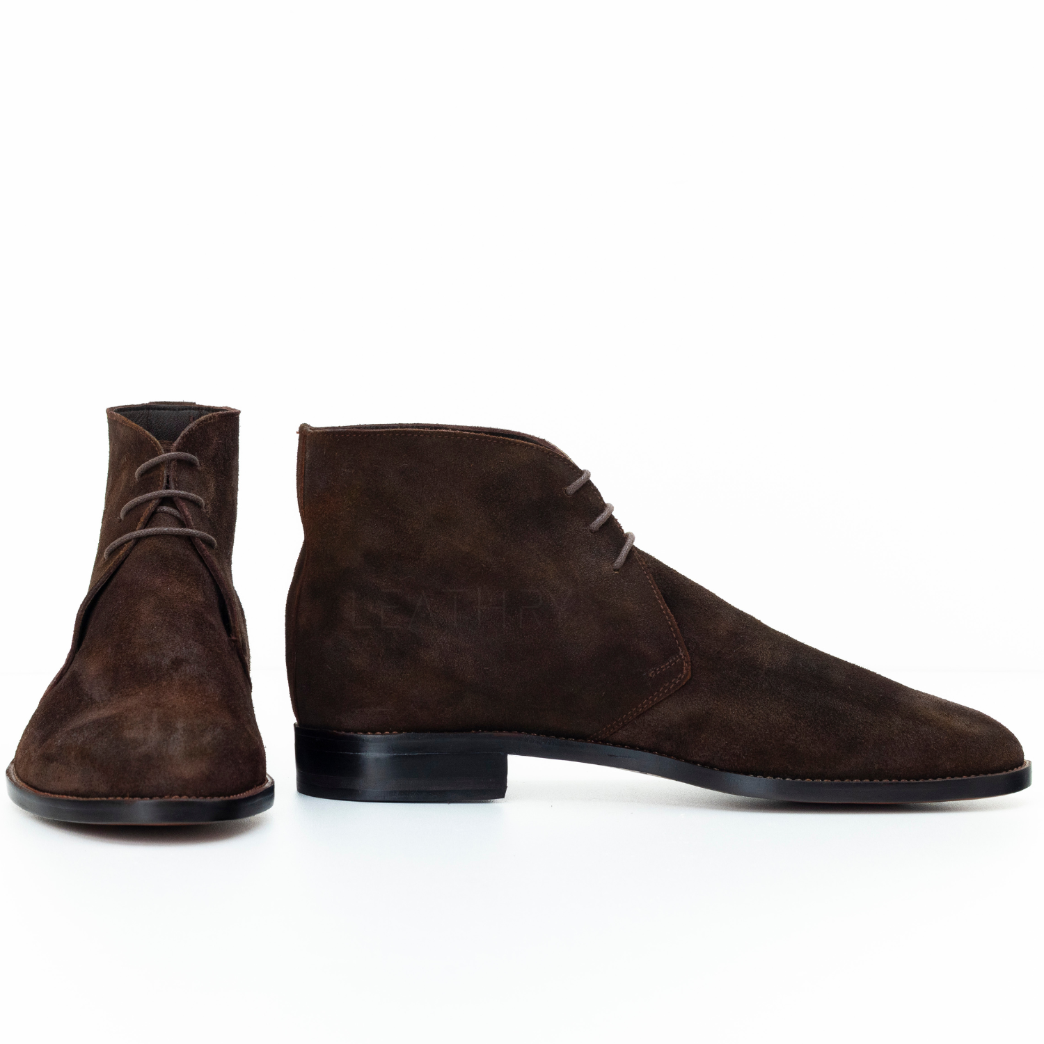 Pair of brown suede boots on a white background