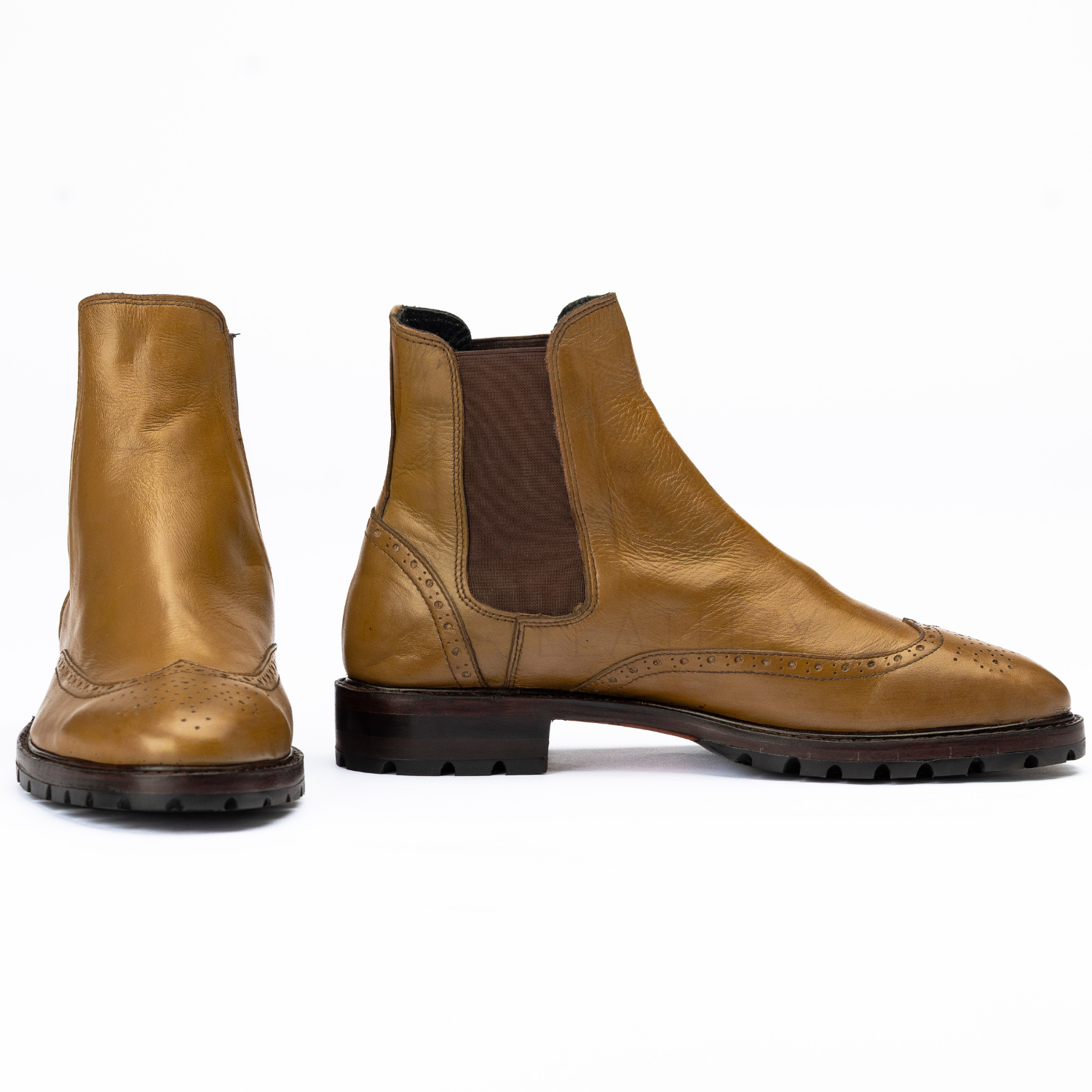 Pair of brown leather boots on a white background